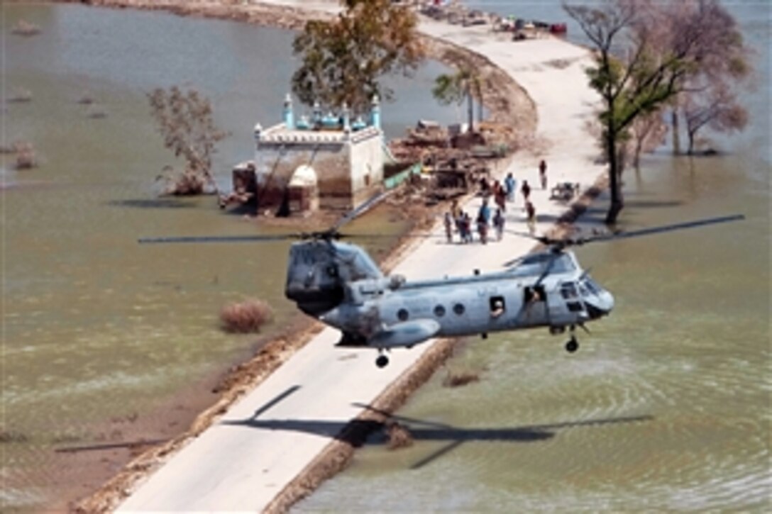 A U.S. Marine Corps Sea Knight helicopter performs a main mount hover on a strip of road too narrow for a full landing in the southern province of Sindh, Pakistan, to deliver relief supplies during humanitarian-assistance operations, Sept. 26, 2010. The helicopter is assigned to the 15th Marine Expeditionary Unit.
