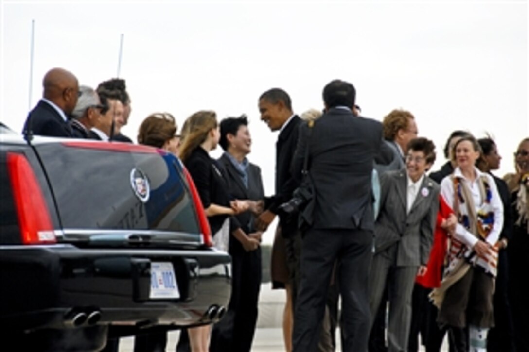 President Barack Obama greets well-wishers upon his arrival at the Wisconsin Air National Guard's 115th Fighter Wing base on Truax Field in Madison, Wis., Sept. 28, 2010. The president visited the base en route to an appearance at the University of Wisconsin. This is the second time a sitting president has visited the 115th Fighter Wing.
