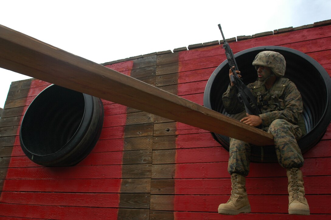Recruit Gabriel Nunez, Platoon 1026, Company B, attempts to solve the logistical problem of using two planks to cross three open areas during the 12-stall portion of the Crucible at Edson Range, Marine Corps Base Camp Pendleton, Calif., Sept. 28. During the 12-stall exercise, leadership positions rotate after each obstacle so every recruit gets a chance to see what leadership is like.