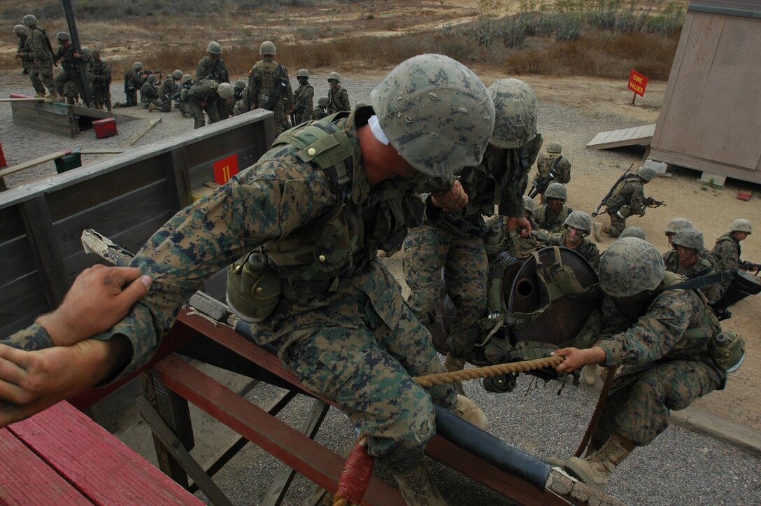 A squad of Company B recruits uses teamwork and communication to quickly accomplish one of their missions during the 12-stall portion of the Crucible at Edson Range, Marine Corps Base Camp Pendlton, Calif., Sept. 28. One of the primary reasons recruits must do the 12-stall exercises during the crucible is to improve their leadership, teamwork and communication abilities which many believe to be key to an effective fighting force.