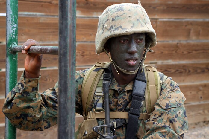 Recruit Paul W. Wangai waits his turn to negotiate an obstacle at Edson Range, Marine Corps Base Camp Pendleton, Calif., Sept. 28. Wangai graduated from recruit training Oct. 8 with the other members of his company. Wangai is a recruit with Platoon 1026, Company B, and a Kenya native.