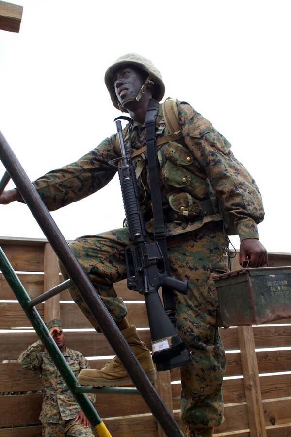 Recruit Paul W. Wangai carries an ammunition can up a ladder on a 12-Stall obstacle at Edson Range, Marine Corps Base Camp Pendleton, Calif., Sept. 28. Wangai left Kenya at the age of 17 and has since then sought the opportunity to be a Marine. Wangai is a recruit with Platoon 1026, Company B, and a Kenya native.