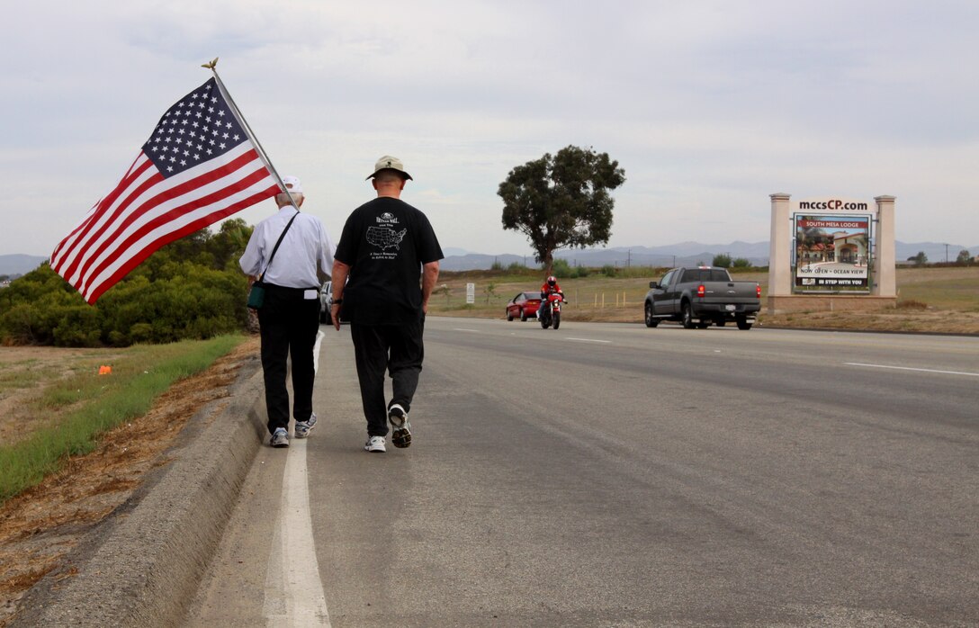 Anthony A. LoBue, better known as Tony the Vet (left), embarks on his journey near Camp Pendleton’s Main Gate with his close friend Robert F. Satterfield, a retired Navy chaplain, Sept. 28. Tony is walking across America in hopes to be at Ground Zero, by Sept. 11, 2011.