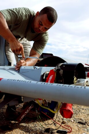 Sgt. James Lyons, 25 from Steubenville, Ohio, Marine Unmanned Aerial Vehicle Squadron 4 avionics technician, performs preflight maintenance on an RQ-7B Shadow unmanned aircraft before the squadron’s inaugural flight at Auxiliary Airfield 2 in Yuma, Ariz., Sept. 28, 2010. During the flight, the squadron showcased the aircraft’s reconnaissance and surveillance capabilities with a live video feed from the Shadow’s onboard camera. The Yuma detachment of the Texas-based reserve squadron is the only operational component of the unit and is composed of mostly active duty Marines. The detachment, which began assembling at the Marine Corps Air Station in Yuma, Ariz., in June, has four Shadows and consists of approximately 40 Marines.