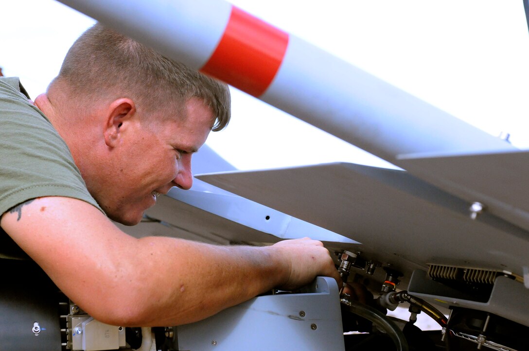 Sgt. Justin Wardlow, 27 from Carbondale, Pa., Marine Unmanned Aerial Vehicle Squadron 4 unmanned aircraft mechanic, performs preflight maintenance on an RQ-7B Shadow unmanned aircraft before the squadron’s inaugural flight at Auxiliary Airfield 2 in Yuma, Ariz., Sept. 28, 2010. During the flight, the squadron showcased the aircraft’s reconnaissance and surveillance capabilities with a live video feed from the Shadow’s onboard camera. The Yuma detachment of the Texas-based reserve squadron is the only operational component of the unit and is composed of mostly active duty Marines. The detachment, which began assembling at the Marine Corps Air Station in Yuma, Ariz., in June, has four Shadows and consists of approximately 40 Marines.