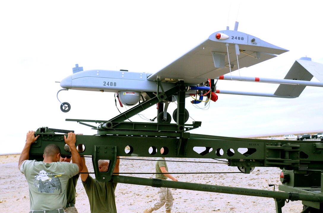 Three Marines from Marine Unmanned Aerial Vehicle Squadron 4 reposition the launcher for an RQ-7B Shadow unmanned aircraft before the squadron’s inaugural flight at Auxiliary Airfield 2 in Yuma, Ariz., Sept. 28, 2010. During the flight, the squadron showcased the aircraft’s reconnaissance and surveillance capabilities with a live video feed from the Shadow’s onboard camera. The Yuma detachment of the Texas-based reserve squadron is the only operational component of the unit and is composed of mostly active duty Marines. The detachment, which began assembling at the Marine Corps Air Station in Yuma, Ariz., in June, has four Shadows and consists of approximately 40 Marines.