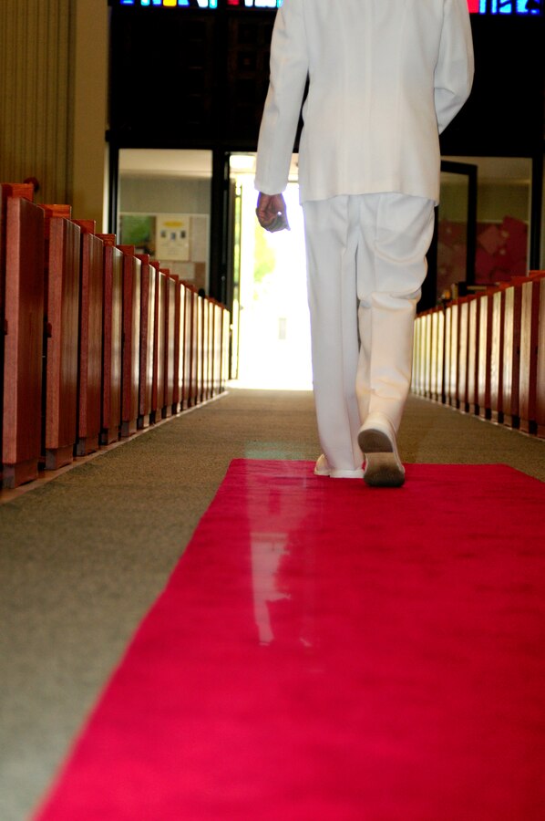 Lt. Cmdr. Carl H. Farmer, Marine Aircraft Group 13 chaplain, walks out of the chapel at the Marine Corps Air Station in Yuma, Ariz., for one of his last times, after the chaplain's retirement ceremony Sept. 28, 2010.