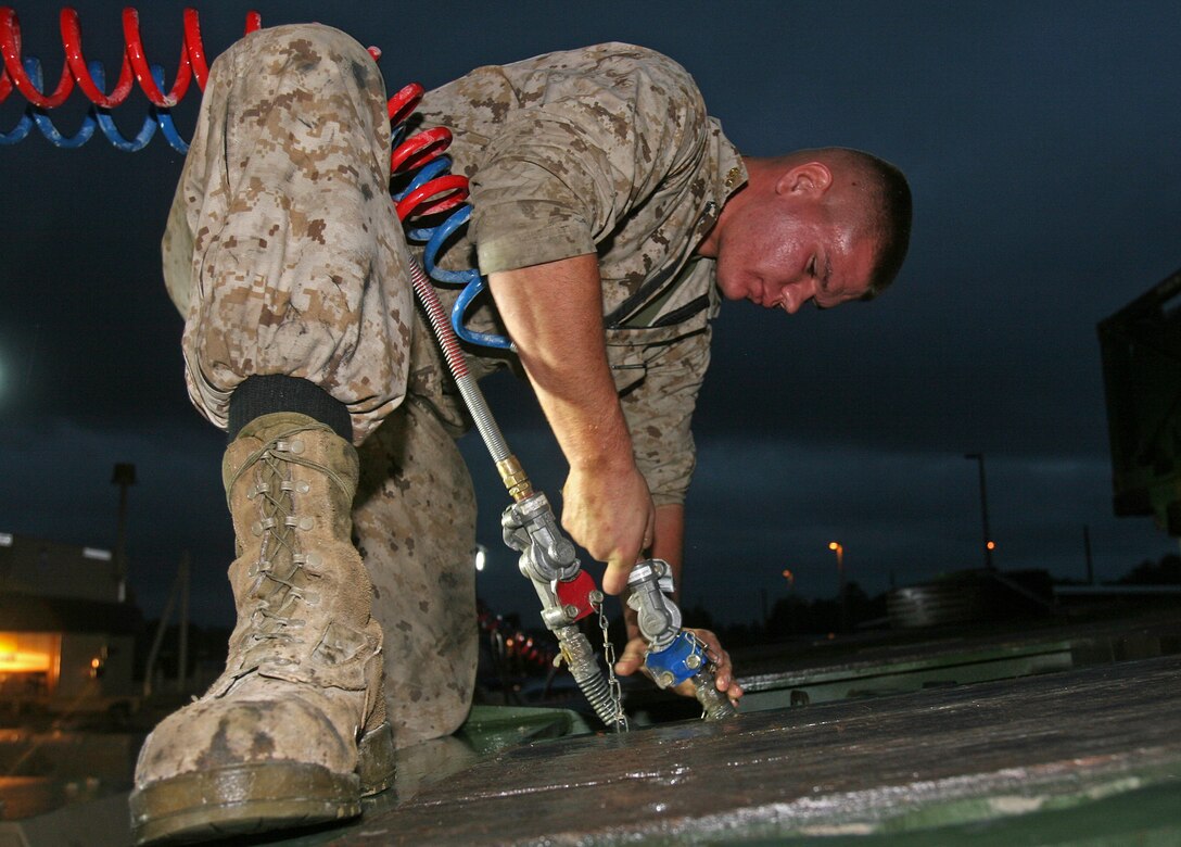 Lance Cpl. Ethan Weisenberger, a logistics vehicle system operator with Marine Wing Support Group 17, 1st Marine Aircraft Wing, I Marine Expeditionary Force, links::r::::n:: a trailer to a Logistics Vehicle System Replacement MKR 16 tractor aboard Marine Corps Base Camp Lejeune, N.C., Sept. 28, 2010. Marines from all three Marine Expeditionary Forces worked together to properly field test two new logistics vehicles that the Marine Corps is researching.::r::::n::