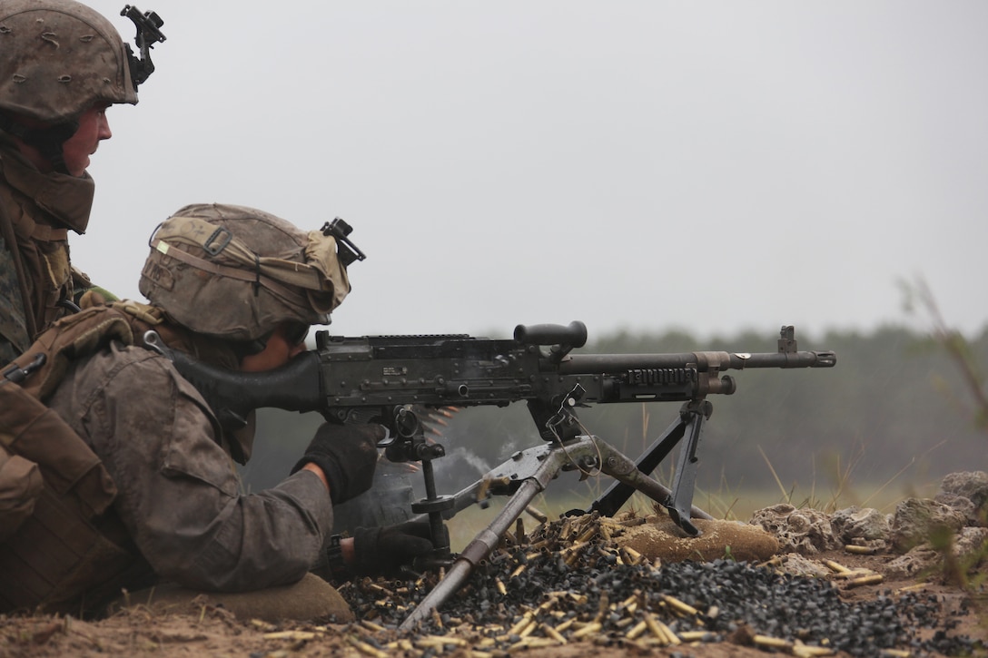 100929-M-6323R-049 MARINE CORPS BASE CAMP LEJEUNE, N.C. - A machine gun team with Echo Company, 2nd Battalion, 2nd Marine Regiment, fire an M-240B medium machine gun during a training evolution aboard Camp Lejeune, N.C., Sept. 29, 2010. Companies Echo, Fox and Golf, conducted a ten day training exercise including a MK-19 40mm automatic grenade launcher training course. (Official Marine Corps photo by Lance Cpl John M. Raufmann)
