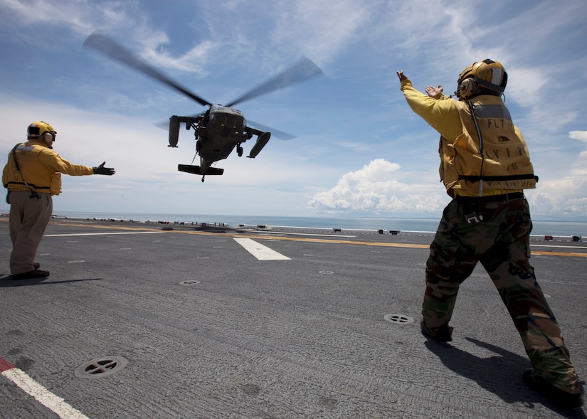 CARIBBEAN SEA --  U.S. Sailors aboard the amphibious assault ship USS Iwo Jima direct a 1-228th Aviation Regiment UH-60 Black Hawk helicopter transporting Nicaraguan officials and media to the ship while off the coast of Bluefields, Nicaragua, Sept. 20. The assigned medical and engineering staffs embarked aboard Iwo Jima are conducting Continuing Promise 2010 with partner nations to provide medical, dental, veterinary and engineering assistance in several nations throughout the U.S. Southern Command area of responsibility. (DoD photo by Sgt. Samuel R. Beyers/U.S. Marine Corps) 