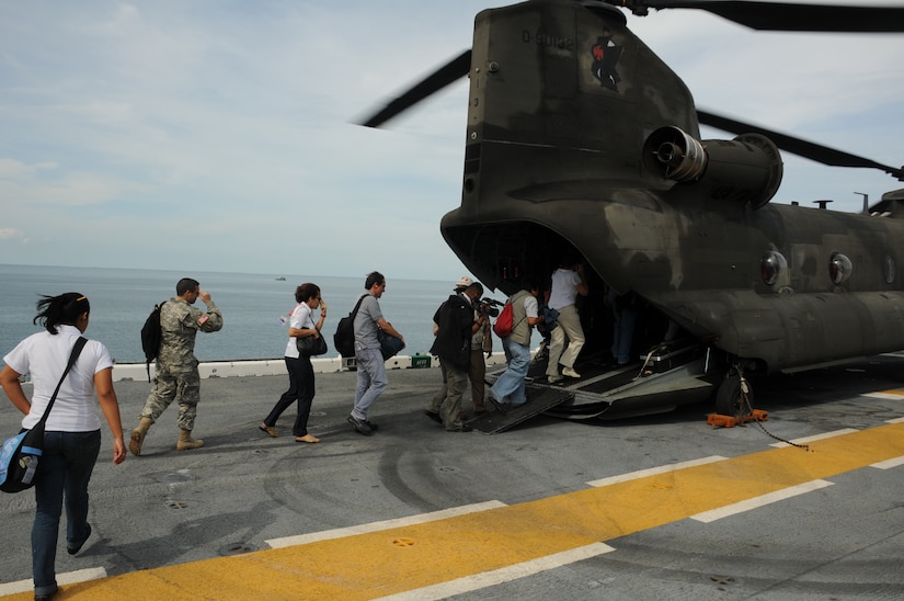 CARIBBEAN SEA -- Military, embassy and media members board a CH-47F Chinook helicopter in preparation to depart the USS Iwo Jima here Sept. 22. The USS Iwo Jima was off the coast of Nicaragua bringing health care and other services to communities in Latin America and the Caribbean during Operation Continuing Promise. (U.S. Air Force photo/Tech. Sgt. Benjamin Rojek)