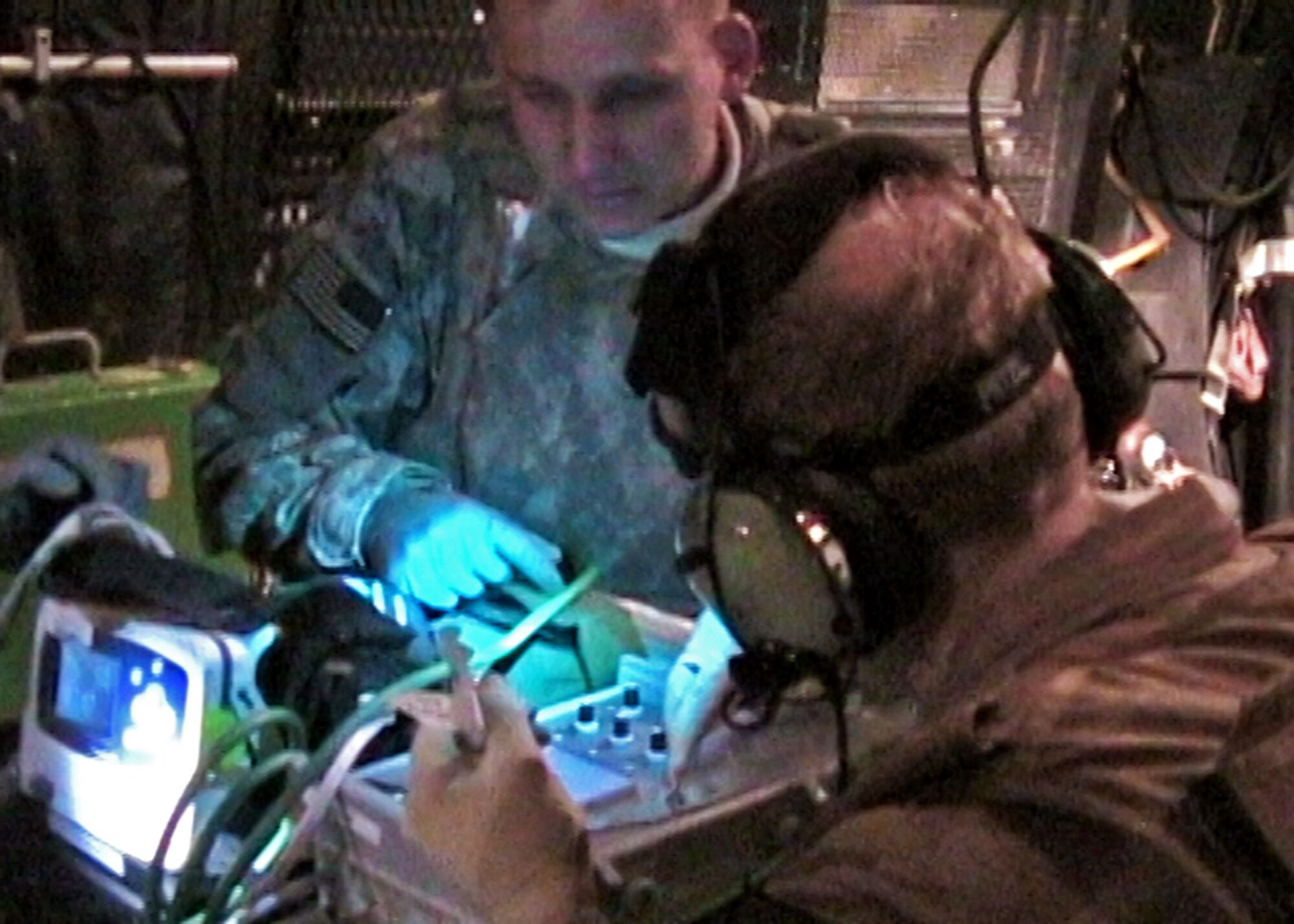 Air Force combat medics watch the vital signs of a critically wounded Afghanistan National Policeman during a medical evacuation mission in 2009.  The mission was flown by a deployed 711th Special Operations Squadron aircrew from Duke Field on their MC-130E Combat Talon I.  The perilous medical evacuation mission, flown at night through blinding snowstorms, was a success in that all the wounded passengers survived after suffering injuries from a suicide bomber.  (Photo still from video source)