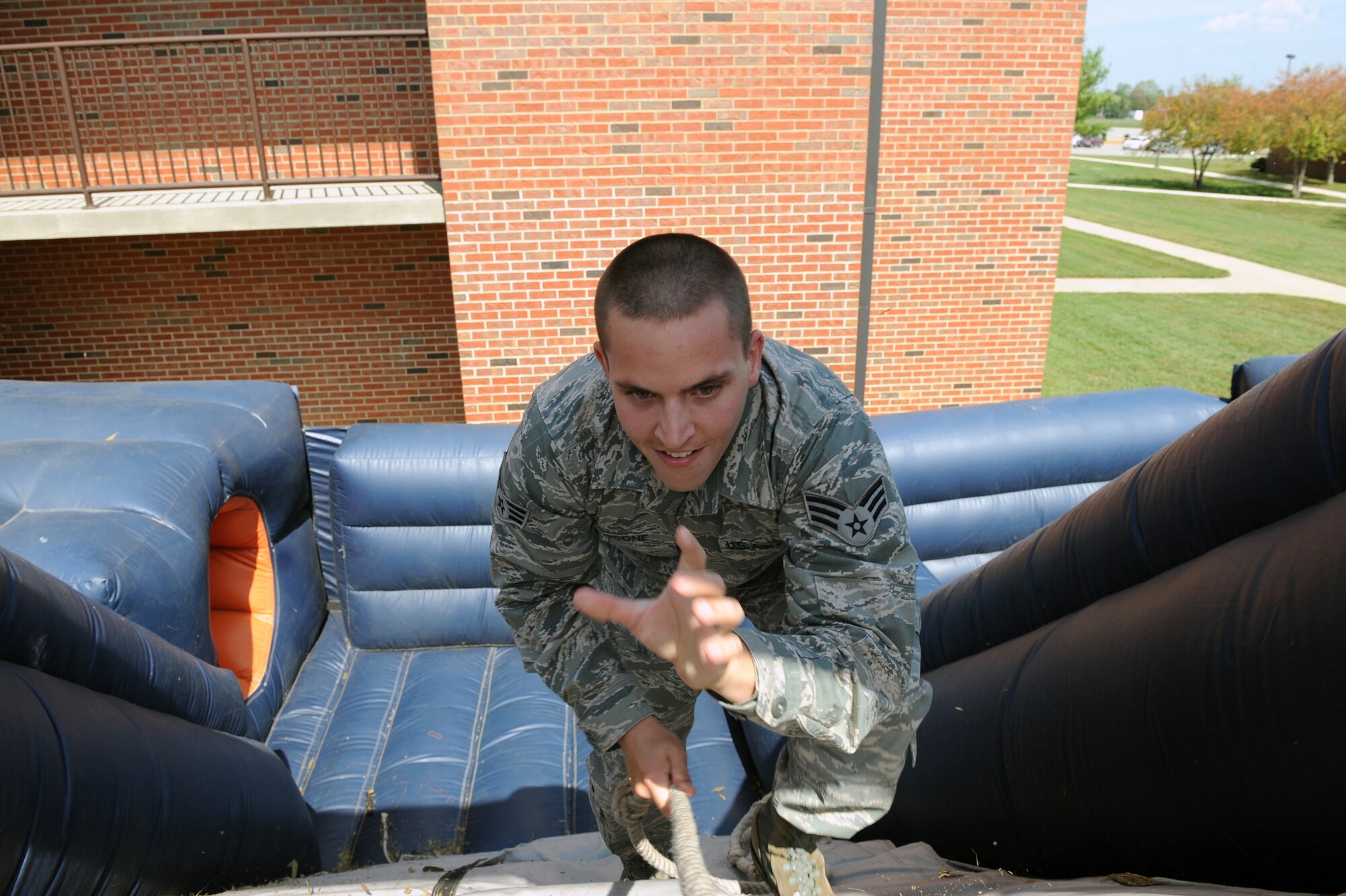 Senior Airman Mark Rosone climbs up an inflatable slide at Suicide Prevention Field Day Sept. 23, 2010, at Scott Air Force Base, Ill. The obstacle course pitted squadron against squadron with the goal of getting the fastest team time. Airman Rosone is a member of the 375th Comptroller Squadron. (U.S. Air Force photo/Senior Airman Tristin English)
