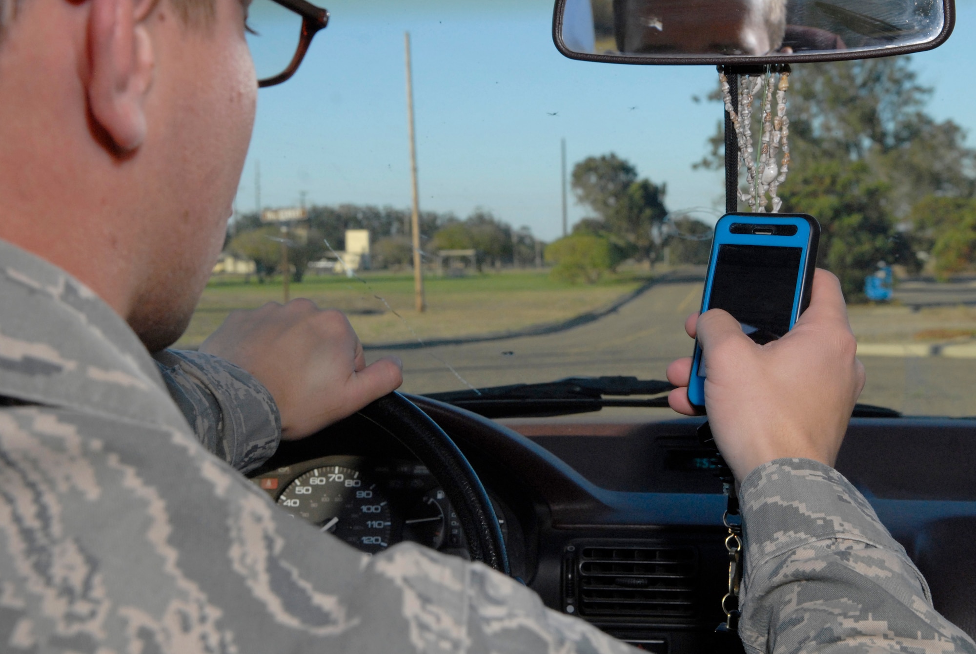 VANDENBERG AIR FORCE BASE, Calif. -- Sending a text message, Airman Gustavo Behrens, a 30th Medical Operations Support Squadron member, simulates driving while texting in a mock vehicle accident scenario here Monday, Sept. 27, 2010. Every six seconds, a driver that sends or receives a text message, he or she spends 4.6 of those seconds with their eyes off of the road.  (U.S. Air Force photo/Senior Airman Andrew Satran) 

 
 
 