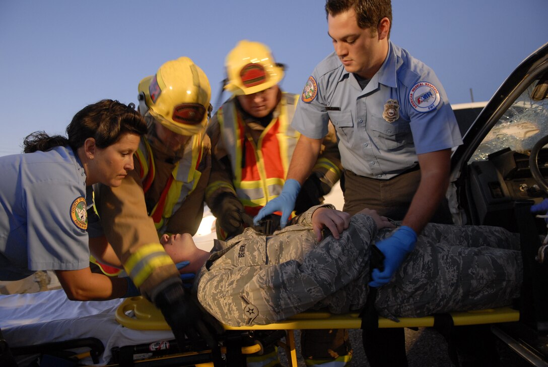 VANDENBERG AIR FORCE BASE, Calif. --  Emergency responders from the base assist an Airman in a mock vehicle accident here Monday, Sept. 27, 2010. The simulated accident stressed the importance of safe driving to prevent accidents from occurring. (U.S. Air Force photo/Senior Airman Andrew Satran) 

 
 