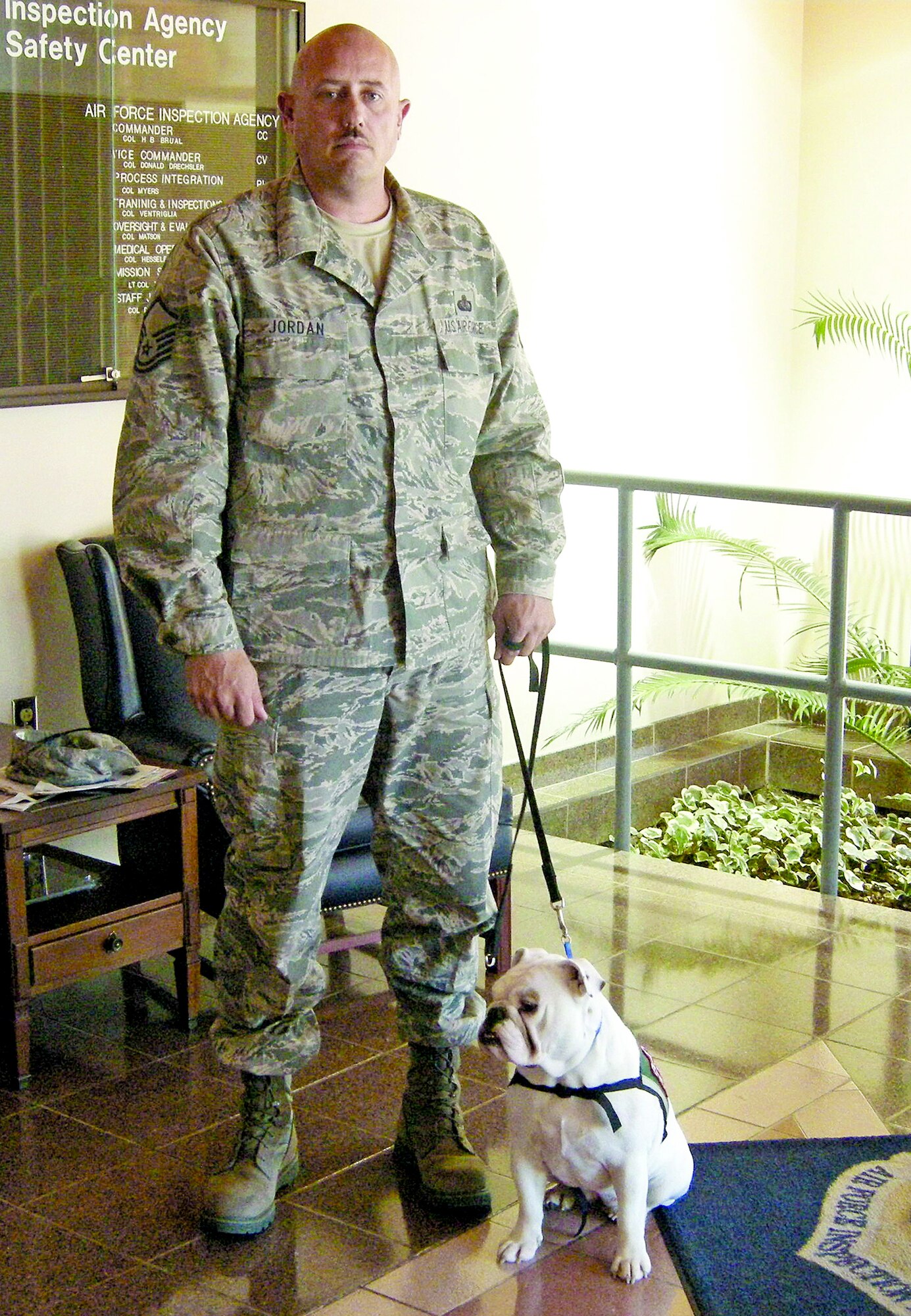 Master Sgt. Justin Jordan takes a break with Dallas, his with two-year-old English Bulldog. Dallas is a service dog trained to help Sergeant Jordan recover from post-traumatic stress disorder. (U.S. Air Force photo)