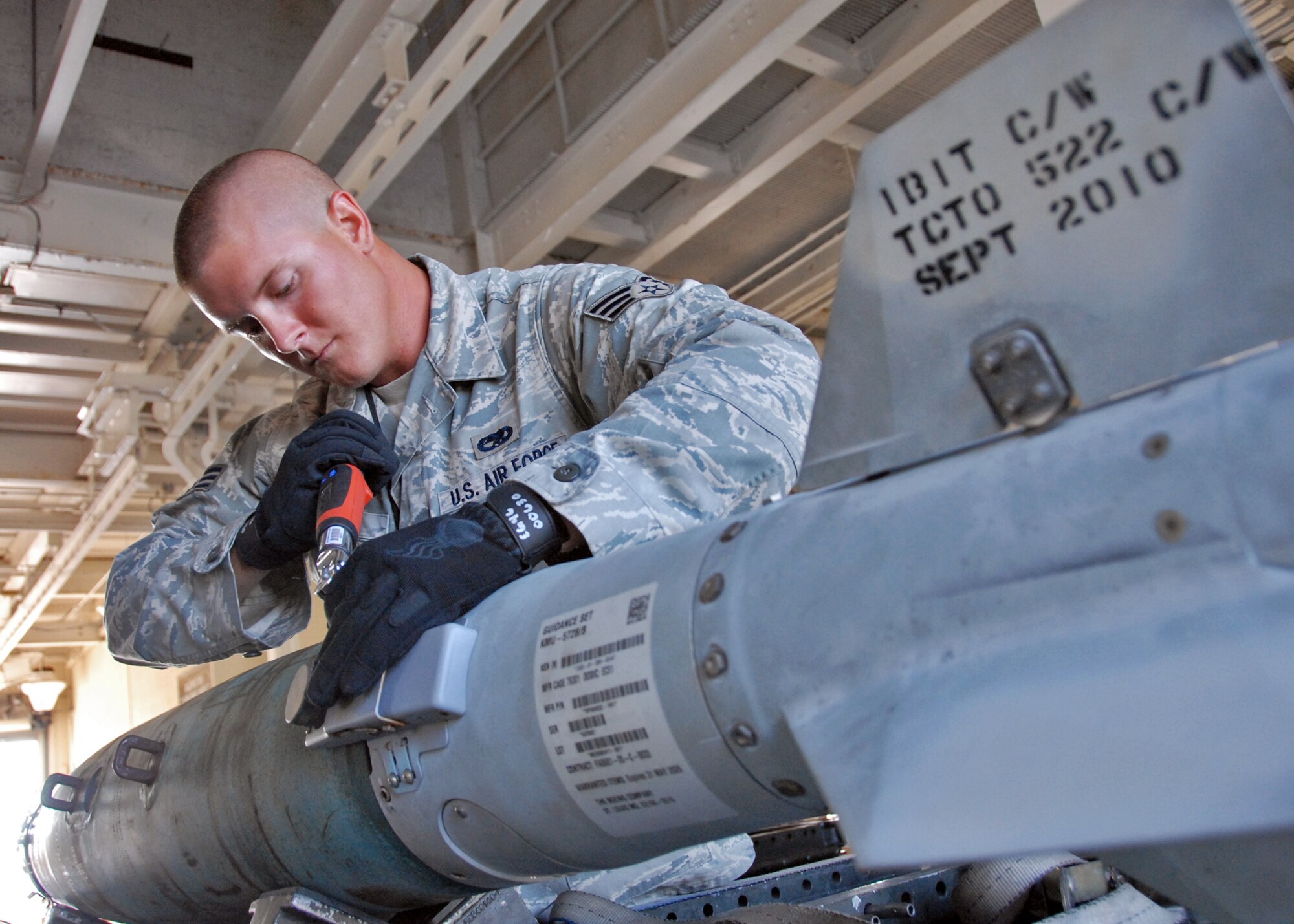Senior Airman Richard Olney, 46th Maintenance Squadron, tightens down the bolts on a Guided Bomb Unit-38 at Eglin Air Force Base, Fla.  Airmen with the 46 MXS build and load bombs for both developmental and operational flight testing.  (U.S. Air Force photo/Samuel King Jr.)