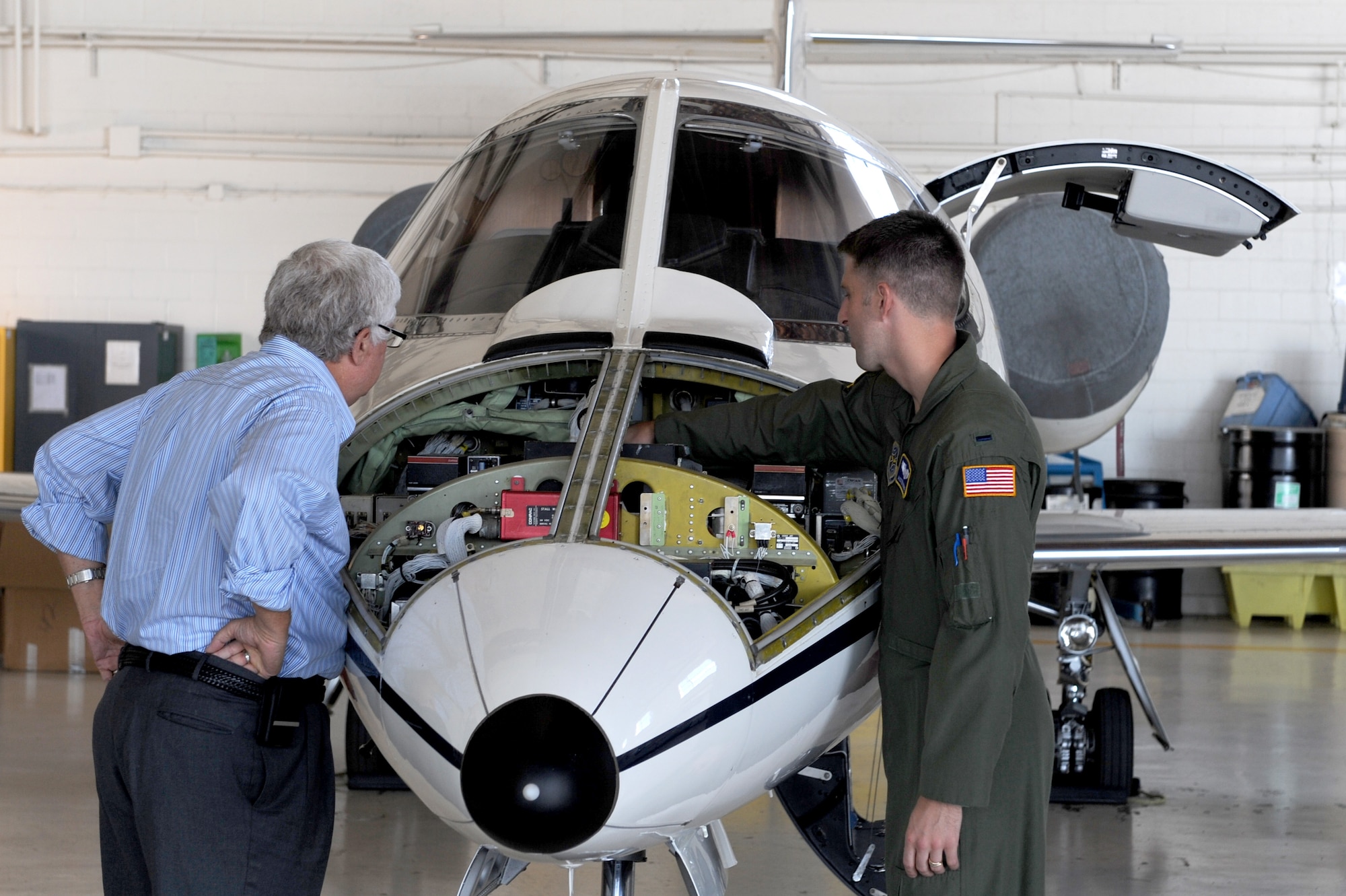 SCOTT AIR FORCE BASE, Ill. -- First Lt. Austin Noble, 458th Airlift Squadron, talks with a retiree at Hangar 3 during Retiree Appreciation Day at Scott AFB, Sept. 25, 2010. Retirees were invited on a base tour where they were able to view the C-21 aircraft, the fire department and a military working dog demonstration. (U.S. Air Force photo by Staff Sgt. Brian J. Valencia)