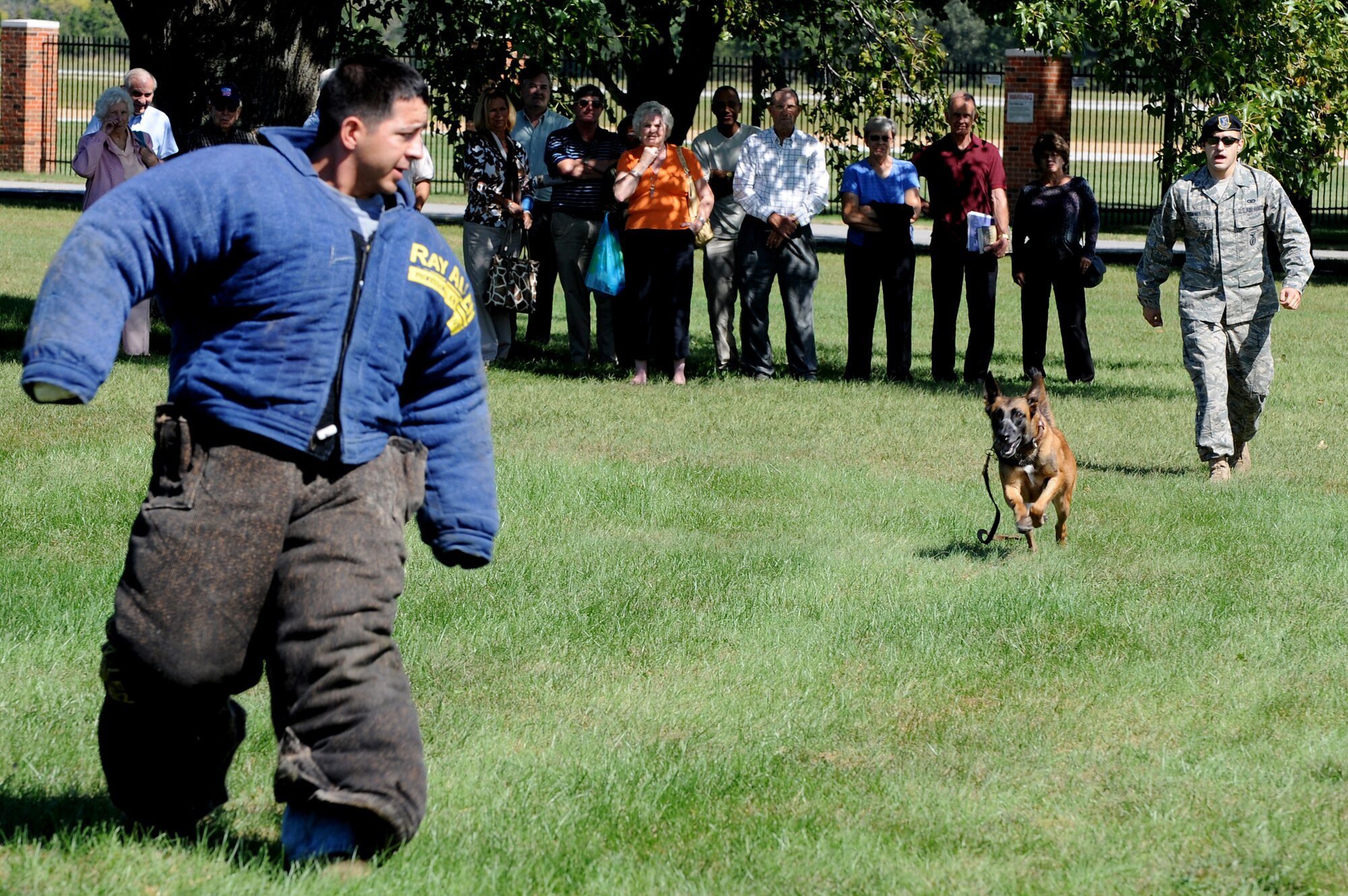 SCOTT AIR FORCE BASE, Ill. -- Staff Sgt. Joshua Sonney, 375th Security Forces Squadron, releases his military working dog, Tilly, on a decoy portrayed by Staff Sgt. Santiago Barnel, 375th SFS, as part of a demonstration during a base tour for Retiree Appreciation Day at Scott AFB, Sept. 25, 2010. The tour also consisted of a viewing of the C-21 aircraft and the fire department. (U.S. Air Force photo by Staff Sgt. Brian J. Valencia)