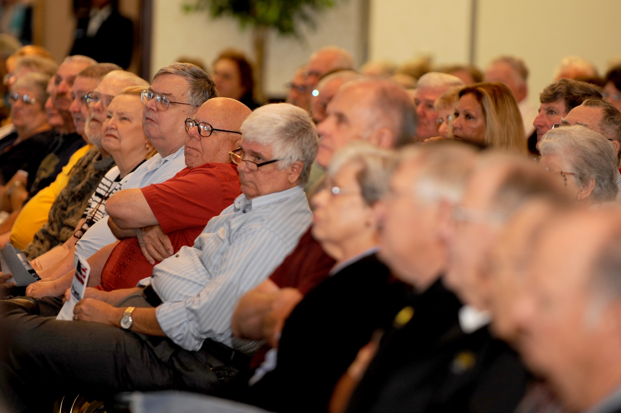 SCOTT AIR FORCE BASE, Ill. -- Retirees listen to the guest speaker, retired Col. James Bohn, during Retiree Appreciation Day at the Scott AFB club, Sept. 25, 2010. At the event, retirees received valuable information about services available to them and were also invited on a base tour where they were able to see the fire department, a working dog demonstration and view the C-21 aircraft. (U.S. Air Force photo by Staff Sgt. Brian J. Valencia)