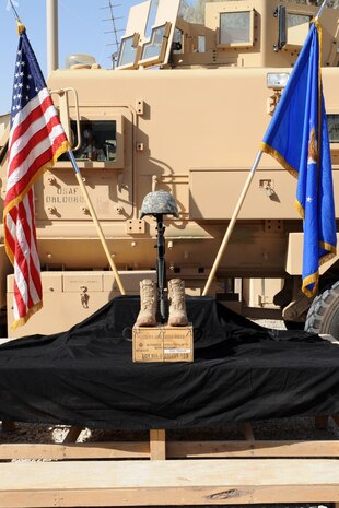 KANDAHAR, Afghanistan-- A memorial for 23-year-old Senior Airman Michael J. Buras, an Explosive Ordinance Disposal journeyman deployed from the 99th Civil Engineer Squadron, Nellis Air Force Base, Nev., stands at Camp Myers Kandahar Airfield, Afghanistan Sept. 27. Airman Buras died Sept. 21 of wounds suffered from an improvised explosive device detonation.  (U.S Air Force photo by Staff Sgt Taylor Worley)