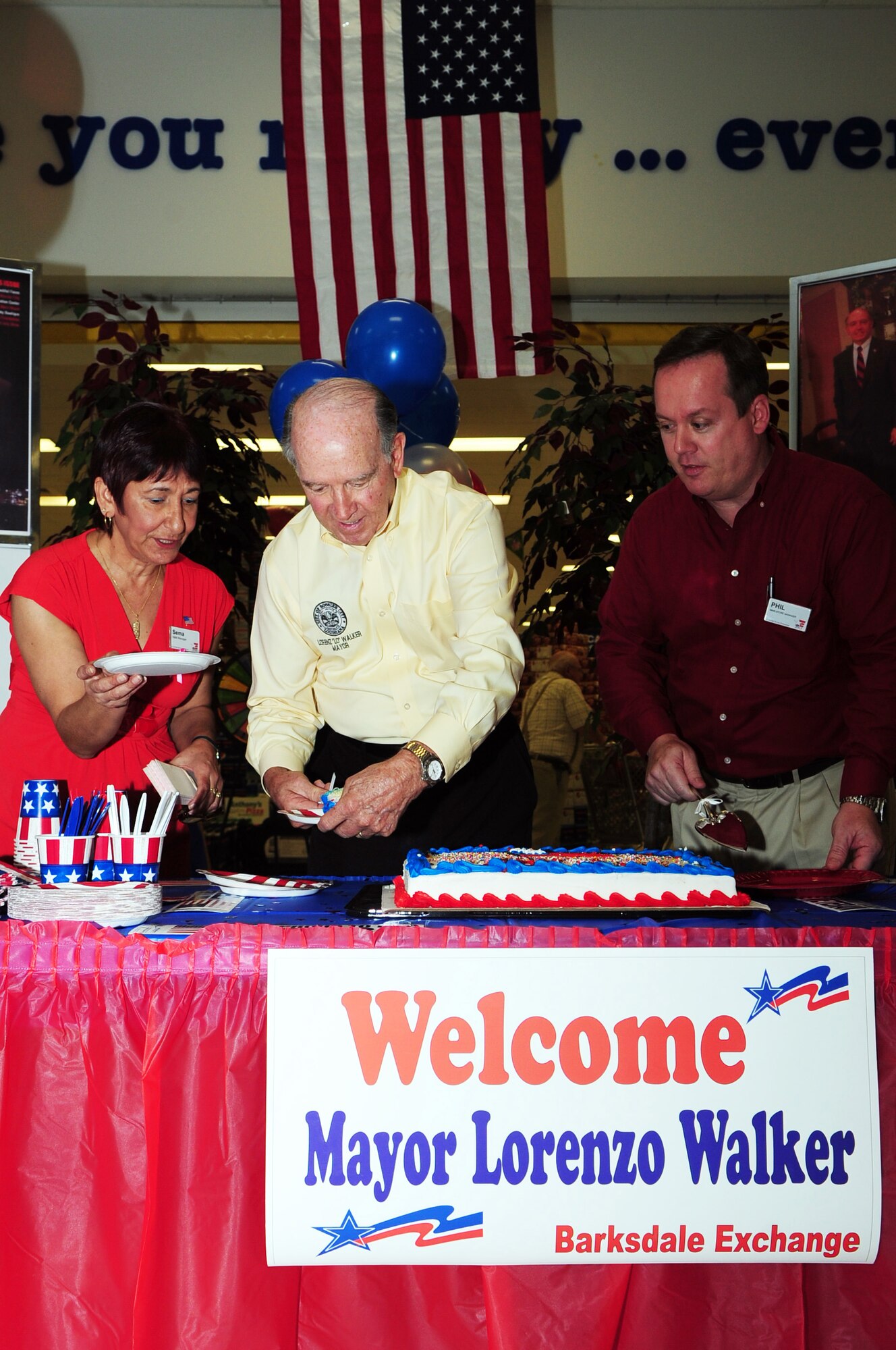 BARKSDALE AIR FORCE BASE, La. -- Mayor Lorenz Walker of Bossier City, La., cuts a cake to kick off the Still Serving event at the Barksdale Base Exchange Sept. 24. The Still Serving event ran from Sept. 24-26 to honor retired veterans and offered free sampling, daily drawings, coupons and manager's specials to exchange customers. (U.S. Air Force photo by Senior Airman Joanna M. Kresge)