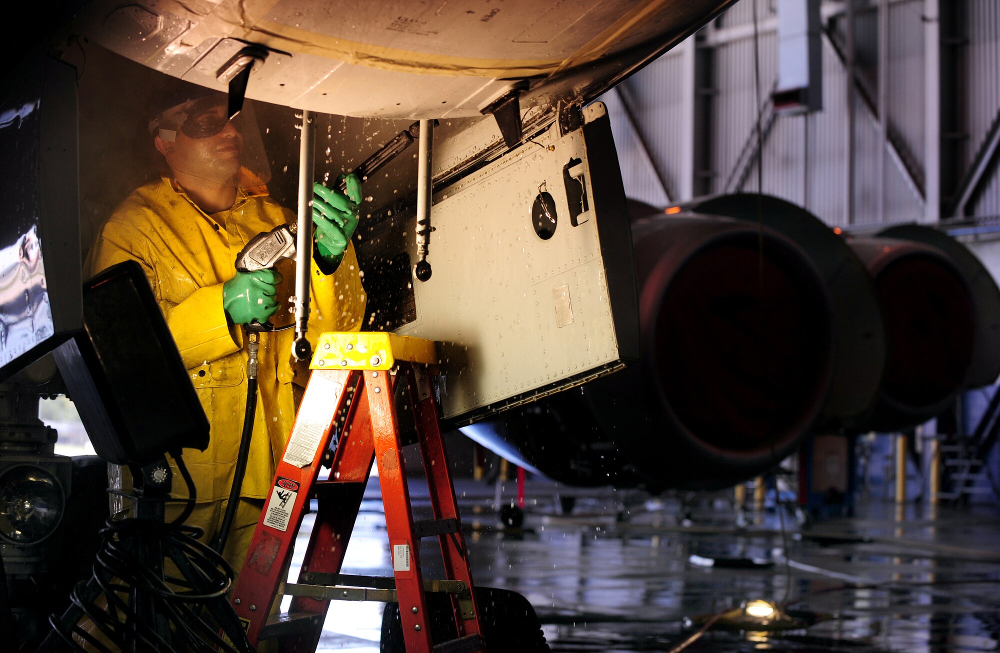 OFFUTT AIR FORCE BASE, Neb. - Airman 1st Class Jorge Martinez-Salinas, of the 55th Aircraft Maintenance Squadron, performs a detailed cleaning inside the front landing gear cavity of an RC-135V Rivet Joint aircraft, inside hangar five of the Bennie Davis Maintenance Facility, Sept. 28.  Roughly ten crew chiefs assigned to the 55th AMXS perform routine cleanings of the airframes which often take up to eight hours to accomplish. The cleanings are part of a minor corrosion and control inspection which is followed by a full lubrication of the entire aircraft once cleaned. U.S. Air Force photo by Josh Plueger