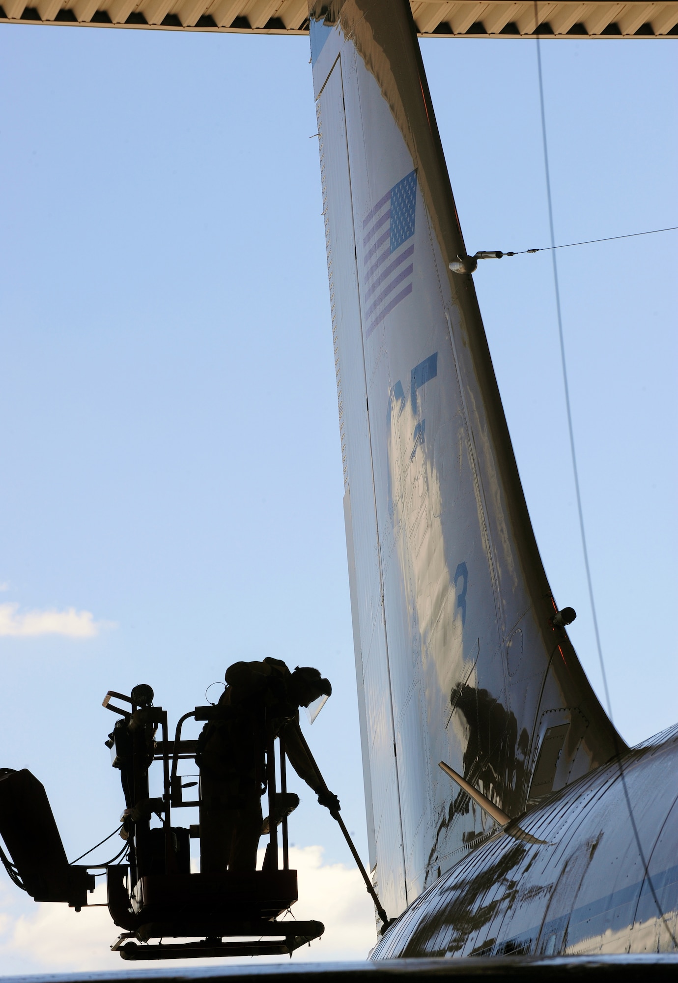 OFFUTT AIR FORCE BASE, Neb. - Staff Sgt. Robert Brushel, of the 55th Aircraft Maintenance Squadron, performs a detailed cleaning on the tail of a RC-135V Rivet Joint aircraft, inside hangar five of the Bennie Davis Maintenance Facility, Sept. 28.  Roughly ten crew chiefs assigned to the 55th AMXS perform routine cleanings of the airframes which often take up to eight hours to accomplish. The cleanings are part of a minor corrosion and control inspection which is followed by a full lubrication of the entire aircraft once cleaned. U.S. Air Force photo by Josh Plueger