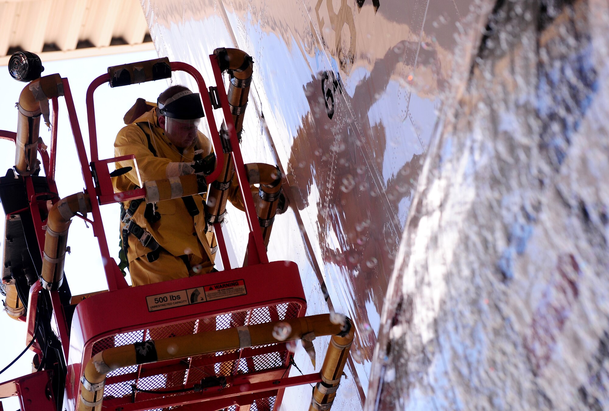 OFFUTT AIR FORCE BASE, Neb. - Staff Sgt. Robert Brushel, of the 55th Aircraft Maintenance Squadron, performs a detailed cleaning on the tail of a RC-135V Rivet Joint aircraft, inside hangar five of the Bennie Davis Maintenance Facility, Sept. 28.  Roughly ten crew chiefs assigned to the 55th AMXS perform routine cleanings of the airframes which often take up to eight hours to accomplish. The cleanings are part of a minor corrosion and control inspection which is followed by a full lubrication of the entire aircraft once cleaned. U.S. Air Force photo by Josh Plueger