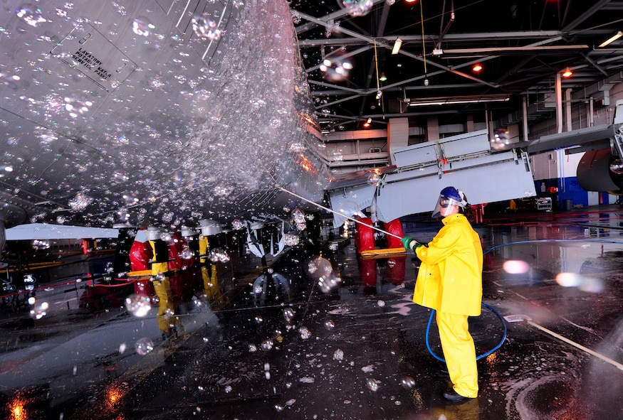 OFFUTT AIR FORCE BASE, Neb. - Airman 1st Class Tia Phakos, of the 55th Aircraft Maintenance Squadron, shoots soap suds onto the tail end of an RC-135V Rivet Joint aircraft, inside hangar five of the Bennie Davis Maintenance Facility, Sept. 28.  Roughly ten crew chiefs assigned to the 55th AMXS perform routine cleanings of the airframes which often take up to eight hours to accomplish. The cleanings are part of a minor corrosion and control inspection which is followed by a full lubrication of the entire aircraft once cleaned. U.S. Air Force photo by Josh Plueger