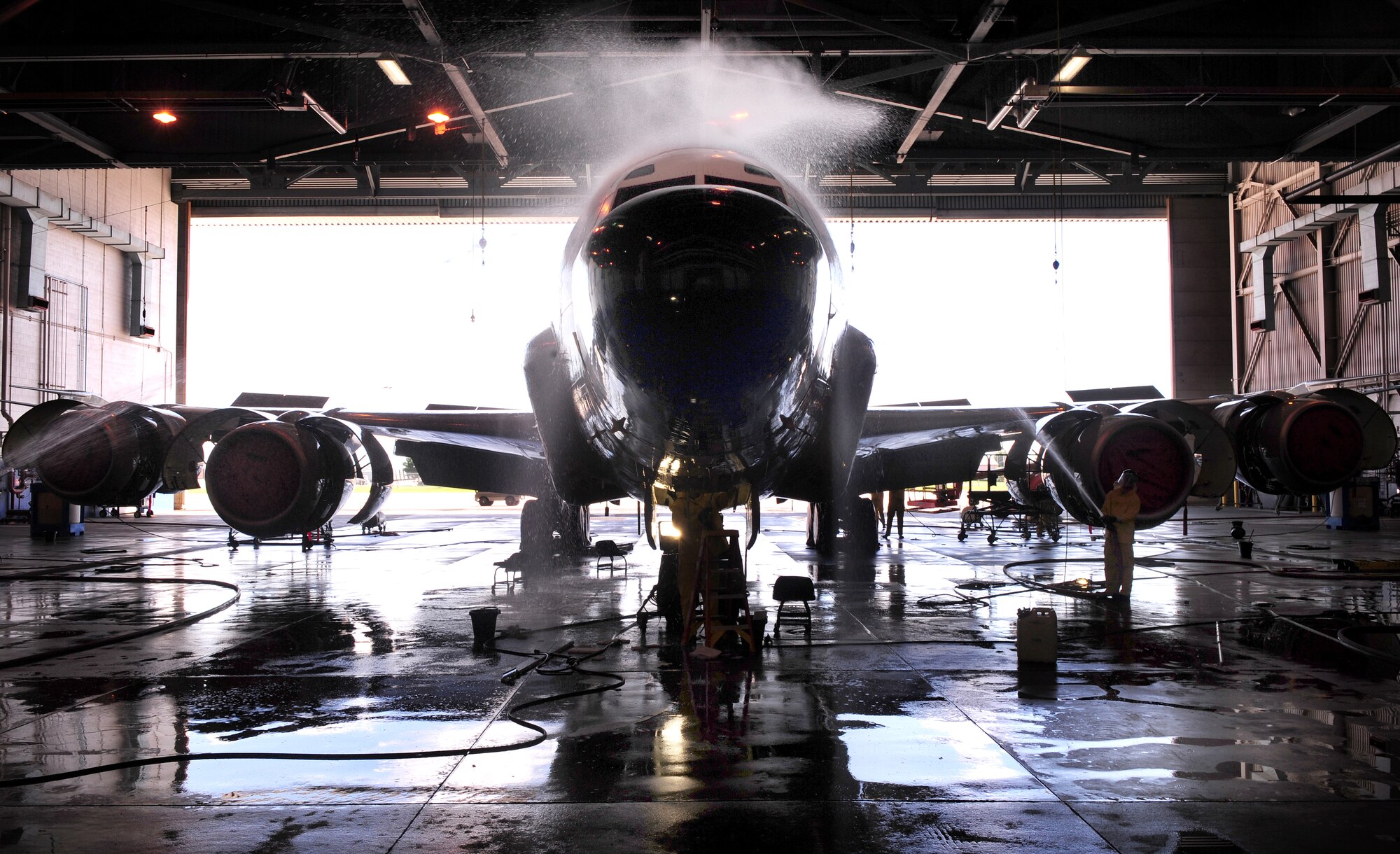 OFFUTT AIR FORCE BASE, Neb. - An RC-135V Rivet Joint aircraft gets hosed down in hangar five of the Bennie Davis Maintenance Facility, Sept. 28.  Roughly ten crew chiefs assigned the 55th Aircraft Maintenance Squadron perform routine cleanings of the airframes which often take up to eight hours to accomplish. The cleanings are part of a minor corrosion and control inspection which is followed by a full lubrication of the entire aircraft once cleaned. U.S. Air Force photo by Josh Plueger