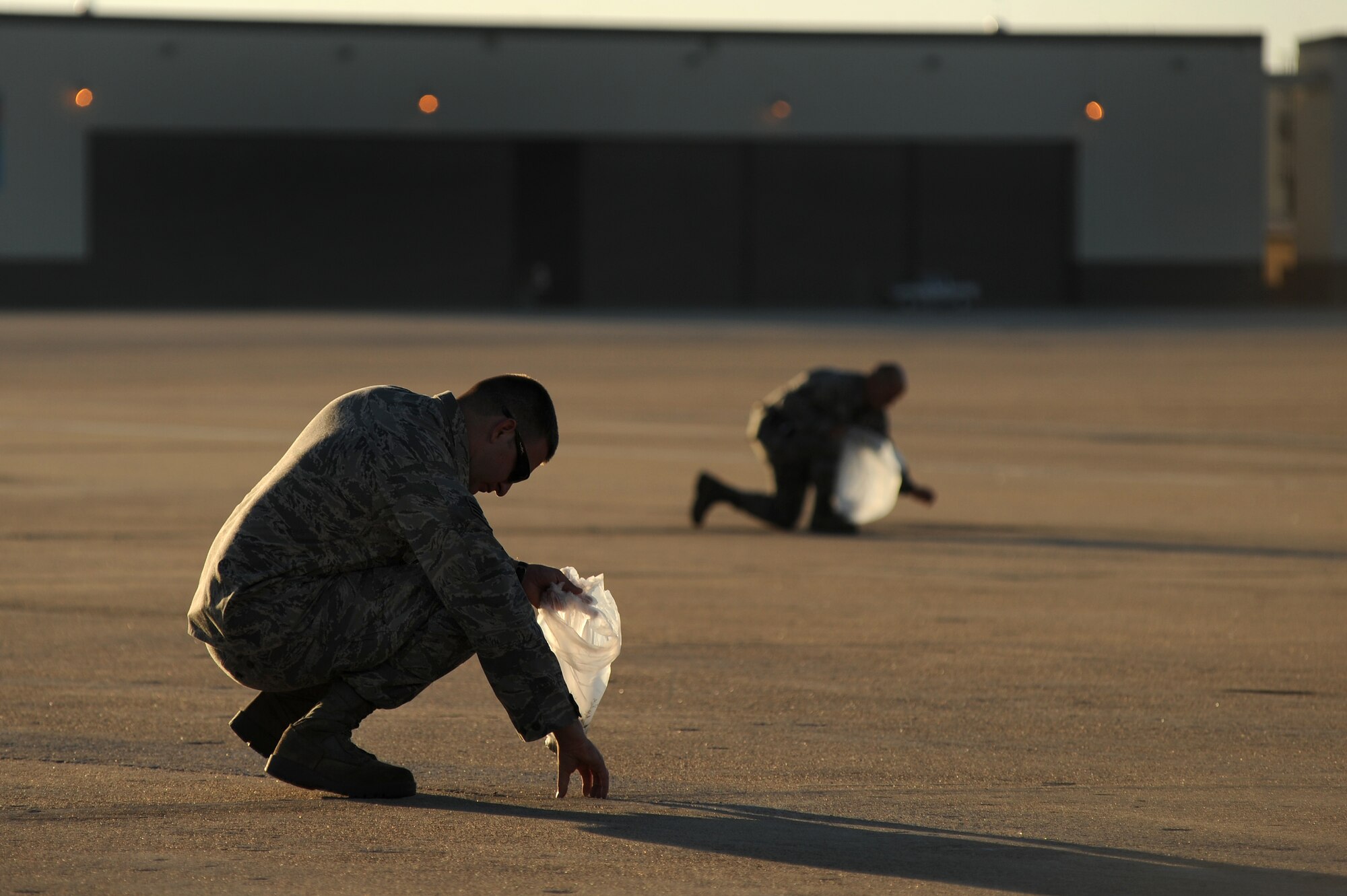 WHITEMAN AIR FORCE BASE, Mo. -- Maintainers and crew chiefs with the 509th Maintenance Squadron and 131st Bomb Wing perform a Foreign Object Debris walk before starting their day, Sept. 28, 2010. FOD mishaps can potentially result in extensive aircraft damage, ultimately hindering the Air Force's flying mission. To counter such events, crew chiefs, maintainers and other personnel working on the  flightline take responsibility for eliminating FOD to keep the aircraft safe and the flying mission soaring. (U.S. Air Force photo by Senior Airman Kenny Holston)(Released) 

