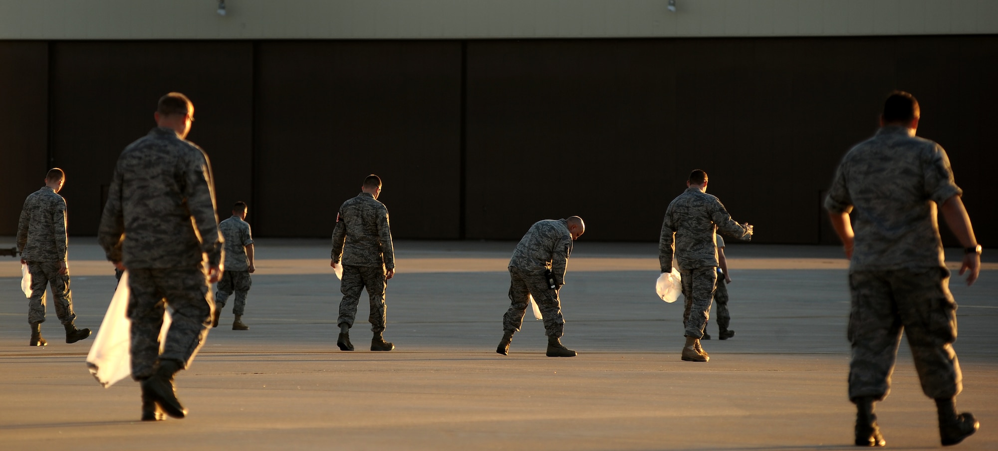 WHITEMAN AIR FORCE BASE, Mo. -- Maintainers and crew chiefs with the 509th Maintenance Squadron and 131st Bomb Wing perform a Foreign Object Debris walk before starting their day, Sept. 28, 2010. FOD mishaps can potentially result in extensive aircraft damage, ultimately hindering the Air Force's flying mission. To counter such events, crew chiefs, maintainers and other personnel working on the flightline take responsibility for eliminating FOD to keep the aircraft safe and the flying mission soaring. (U.S. Air Force photo by Senior Airman Kenny Holston)(Released) 

