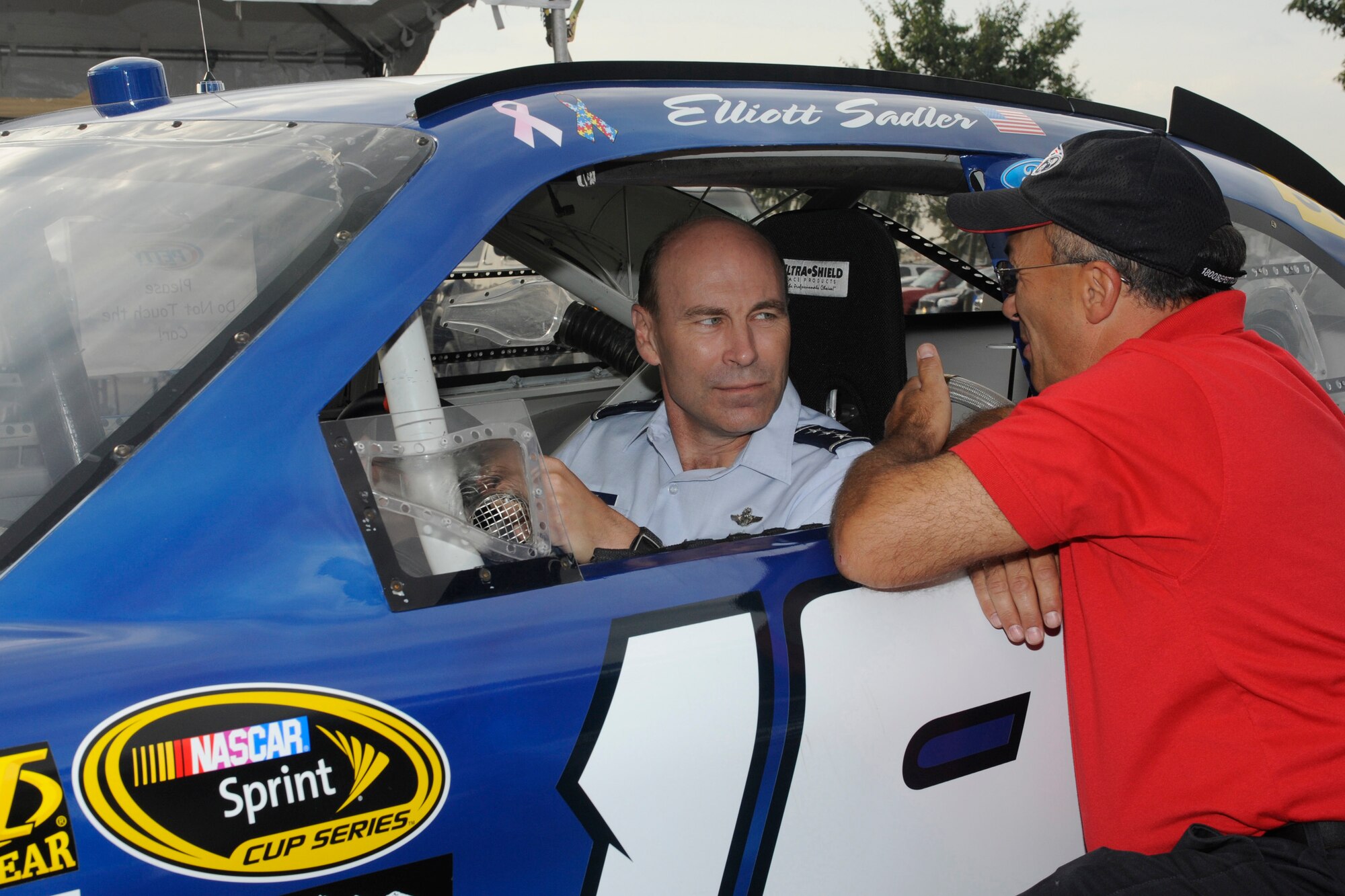U.S. Air Force Lt. Gen. William Rew, Air Combat Command Vice Commander, receives instructions from one of NASCAR and Air Force car driver Elliot Sadler's crew members at Dover International Speedway, Dover, Del., Sept. 26, 2010. Lt. Gen. Rew sat in the Air Force car before the start of the NASCAR Sprint Cup AAA 400 race. (U.S. Air Force photo by John Sidoriak/Released)

