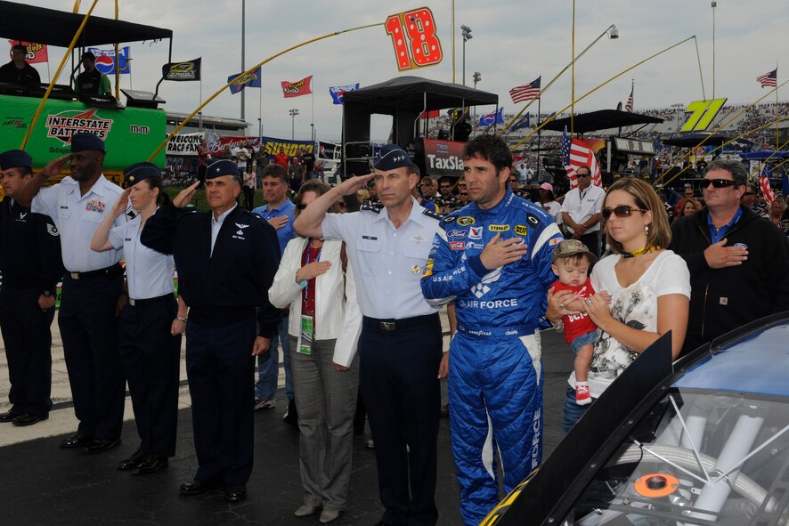 NASCAR Sprint Cup and Air Force car driver Elliott Sadler, Lt. Gen. William Rew and Brig. Gen. William Welch and other Air Force members stand in honor of the National Anthem before the start of the AAA 400 at Dover International Speedway, Dover, Del., Sept. 26, 2010. (U.S. Air Force photo by John Sidoriak/Released)