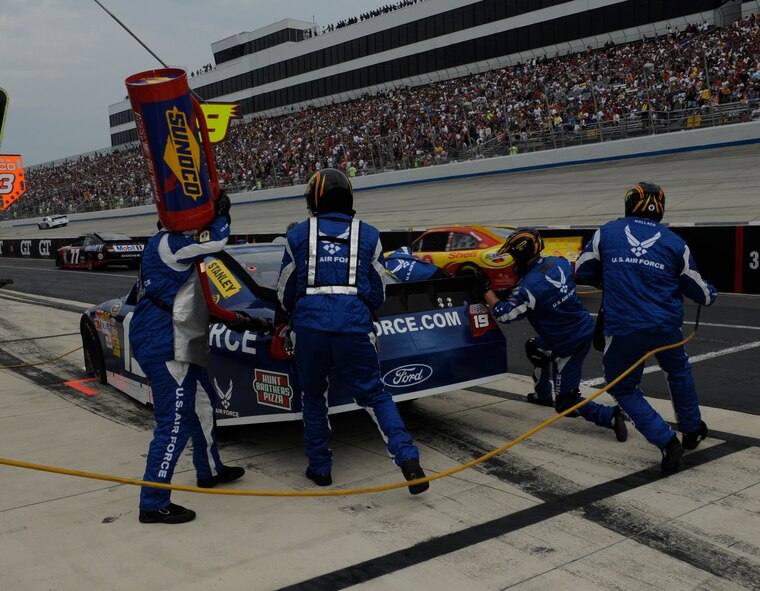Members of Elliot Sadler's pit crew scramble to get the No. 19 Air Force car back in the race at Dover International Speedway, Dover, Del., Sept. 26, 2010. Sadler's Air Force car was one of the 43 competitors in the NASCAR Sprint Cup AAA 400 race. (U.S. Air Force photo by John Sidoriak/Released) 