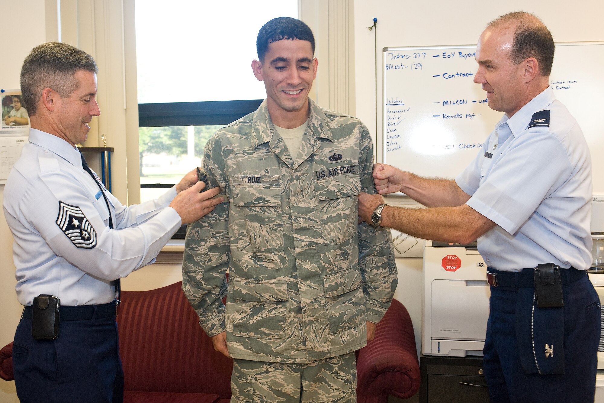 (Left) Chief Master Sgt. David E. Spector, Command Chief Master Sergeant for Air Mobility Command, and Col. Manson Morris, 436th Airlift Wing commander, tack on technical sergeant stripes for Tech. Sgt. Alex Ruiz on Sept. 20, 2010, at Dover Air Force Base, Del. Sergeant Ruiz was promoted through the Stripes for Exceptional Performers program. (U.S. Air Force Photo/Mr. Roland Balik)