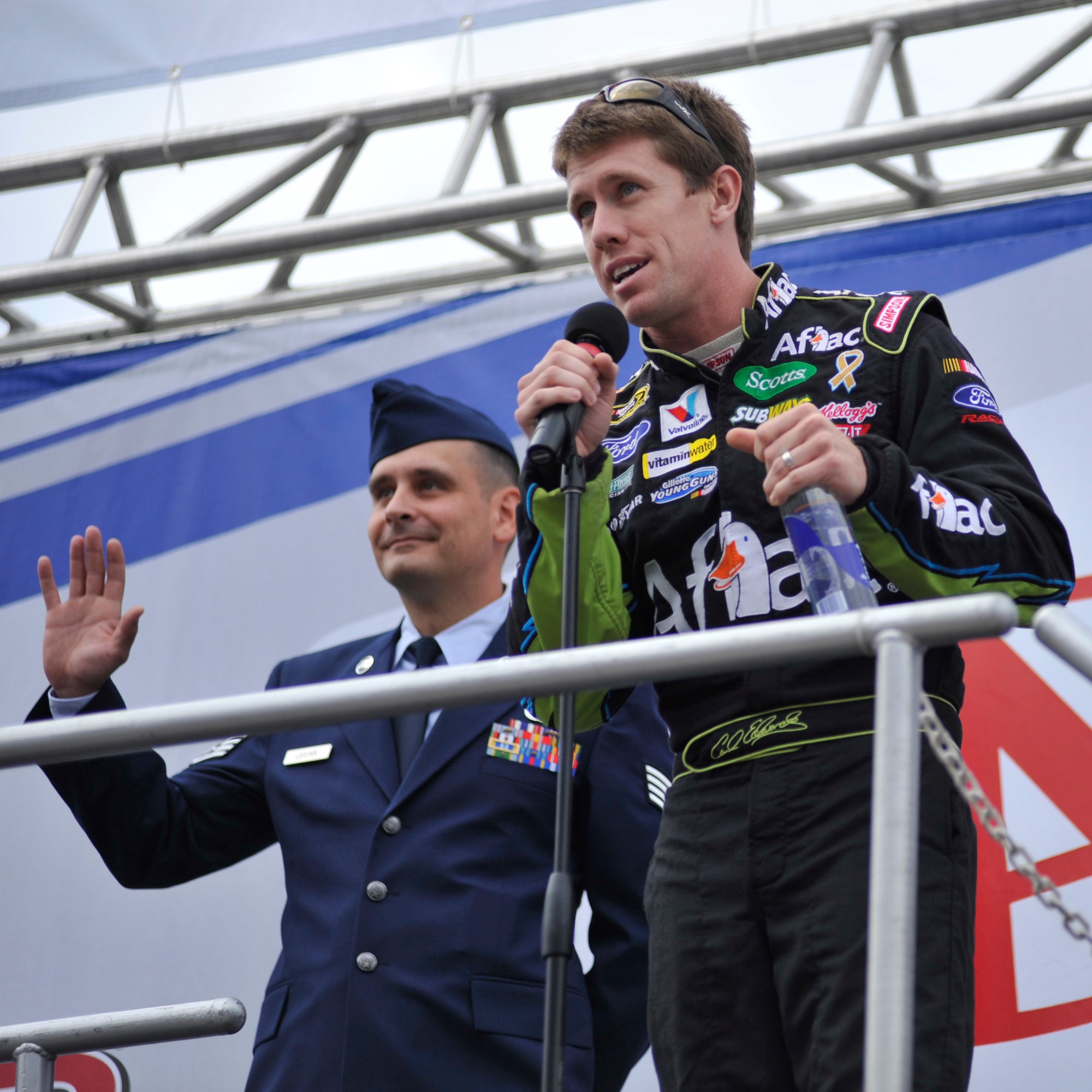 NASCAR Sprint Cup driver Carl Edwards introduces Staff Sgt. Jason Lecuyer to the crowd before the start of the AAA 400 at Dover International Speedway, Dover, Del., Sept. 26, 2010. Sergeant Lecuyer was one of two Airmen from Team Dover chosen to be honored at the race. (U.S. Air Force photo by Tech. Sgt. Chuck Walker/Released)