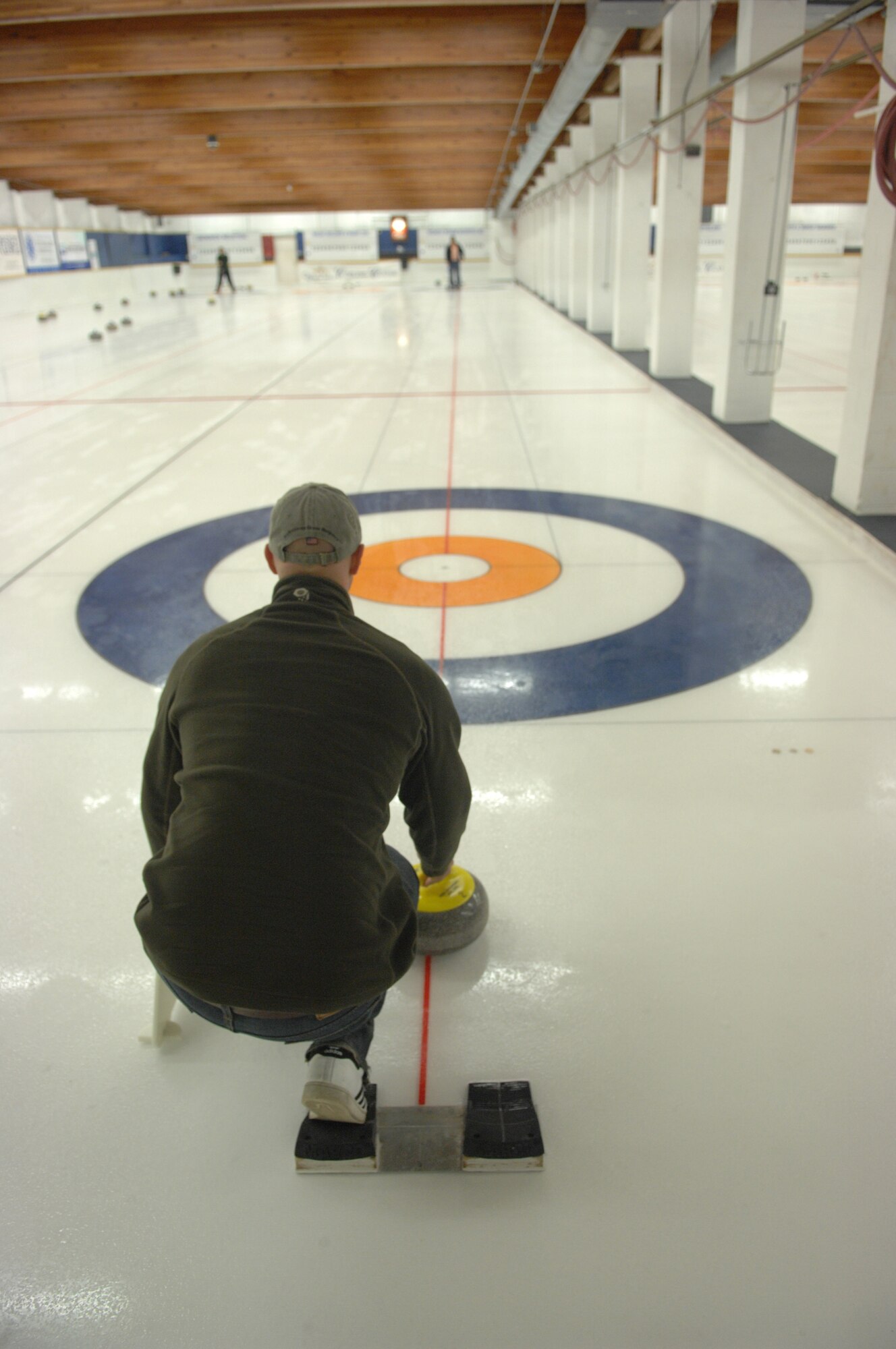 Capt. David Anderson prepares to deliver a stone during the open house weekend at the Fairbanks Curling Club Sept. 25, 2010, Fairbanks, Alaska. The club hosts league games at the Fairbanks Curling Club Monday through Friday nights starting at 7 p.m. Eielson's team is looking for members and is open to active duty military, guard, dependents, retirees and Department of Defense civilians. Captain Anderson is assigned to the 354th Fighter Wing Safety office. (U.S. Air Force photo/ Senior Airman Rachelle Coleman)
