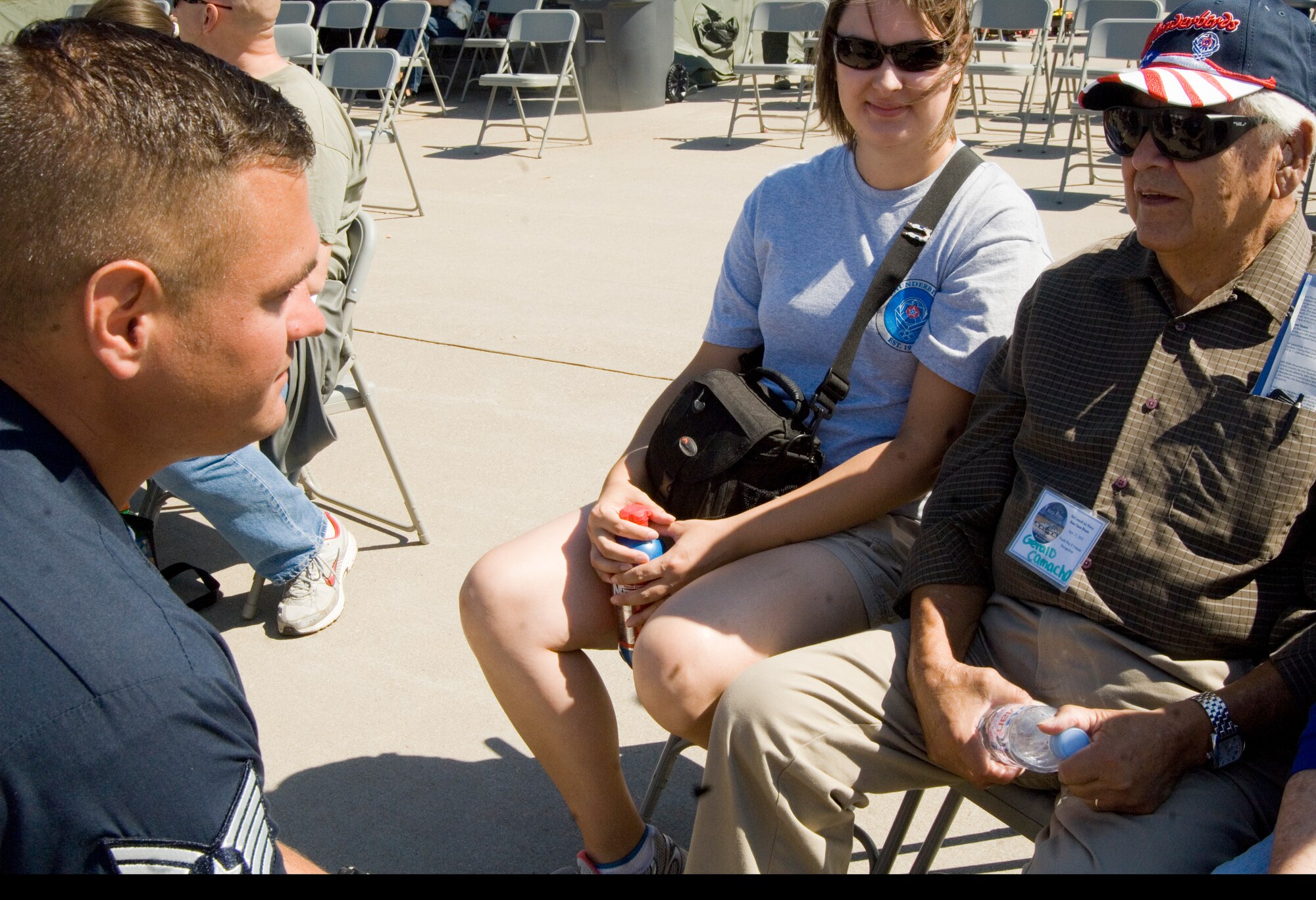 (Left) Tech. Sgt. Cameron Camacho, U.S. Air Force Air Demonstration Squadron radio frequency transmission systems maintenance craftsman, greets his grandfather (right) Gerald Camacho, WWII veteran.  Sergeant Camacho’s grandfather was one of 140 WWII veterans honored during a WWII veteran ceremony that helped kick off McConnell’s 2010 Open House and Air Show.  (U.S. Air Force photo/Senior Airman Abigail Klein)
