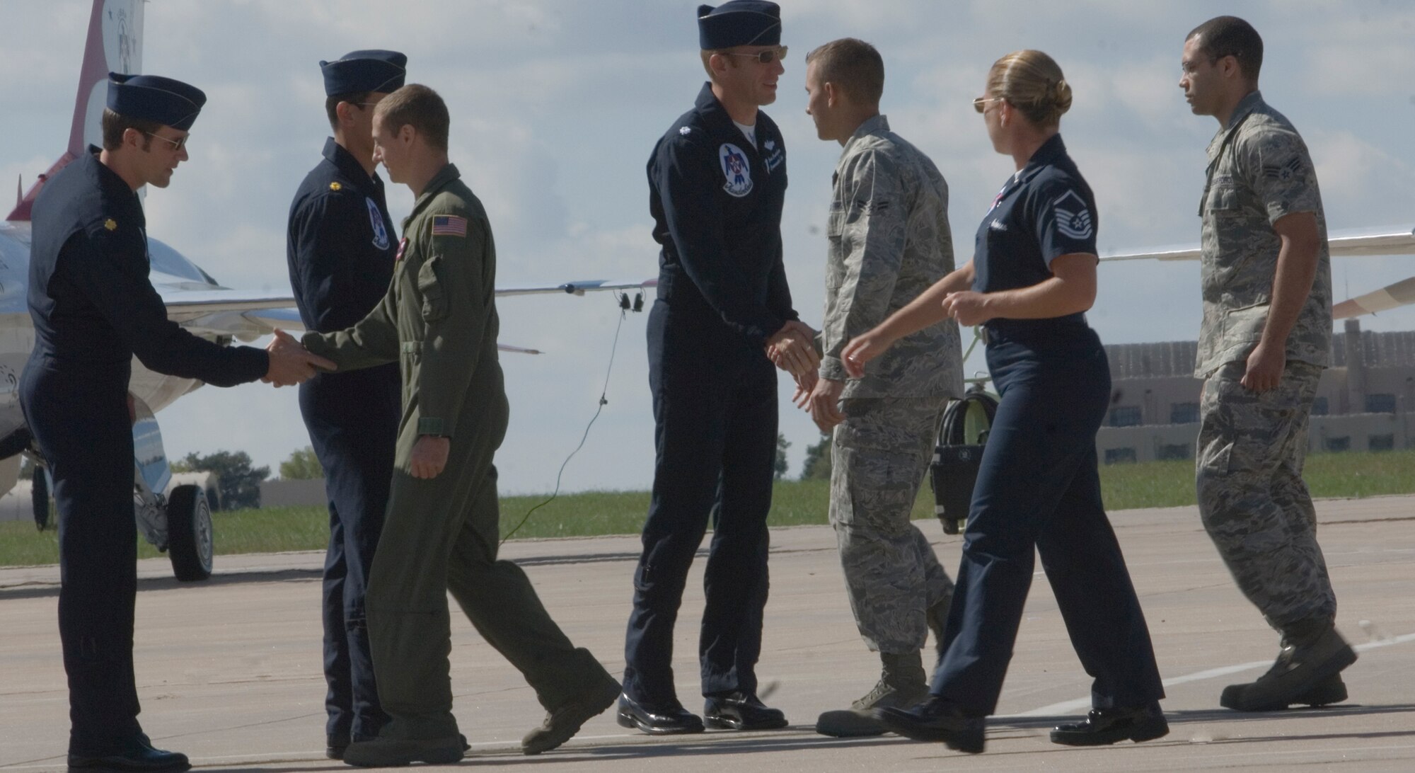 Members of the Thunderbirds, the U.S. Air Force Air Demonstration Squadron, congratulate McConnell Airmen, Tech. Sgt. Phillip Hauser, Senior Airman Armando Dominguez, Airman 1st Class Chadwick Doran and William Pogue Sept. 26, 2010, for their service overseas, McConnell Air Force Base, Kan.  A recognition ceremony was conducted shortly before the Thunderbirds made their scheduled aerial performance.  (U.S. Air Force photo/Senior Airman Abigail Klein)
