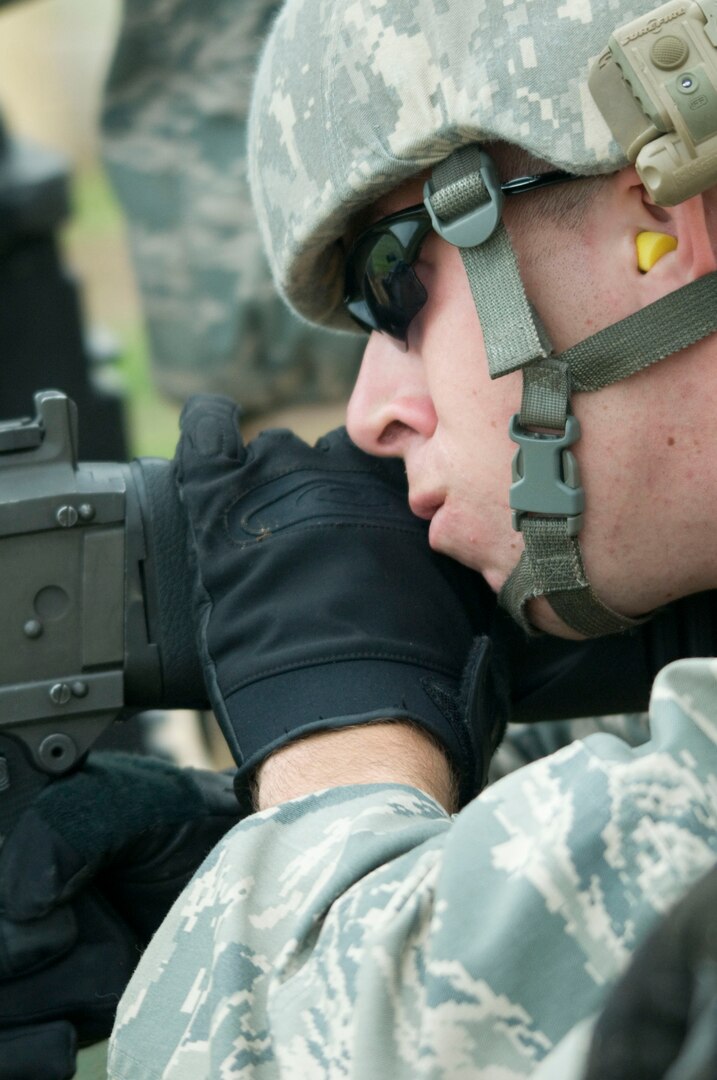 SSgt Johnathan Kuenzli oversees SrA Salvador Gutierrez firing for pre-deployment qualifications. Both are members of 902 ABW/SFS Randolph AFB, TX. (U.S. Air Force photo/Steve White)