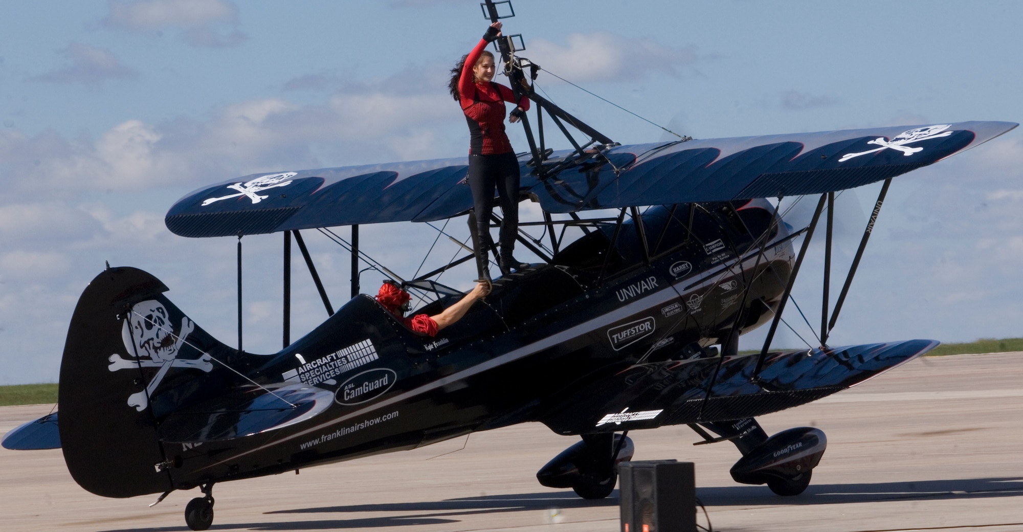 Amanda Franklin (Scandalous Scarlett) waves to guests of McConnell’s 2010 Open House and Air Show Sept. 26, 2010, McConnell Air Force Base.  Amanda and her husband Kyle performed a wing walking act aboard their Waco Mystery Ship. (U.S. Air Force photo/Senior Airman Abigail Klein)