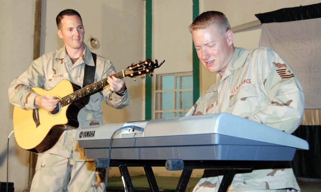 Tech. Sgt. Jonathan McPherson and Master Sgt. Matthew Ascione perform a "light-and-lean" acoustic show at a community development in the capital city of Djibouti during a deployment on October 25, 2007.  (US Air Force Photo)