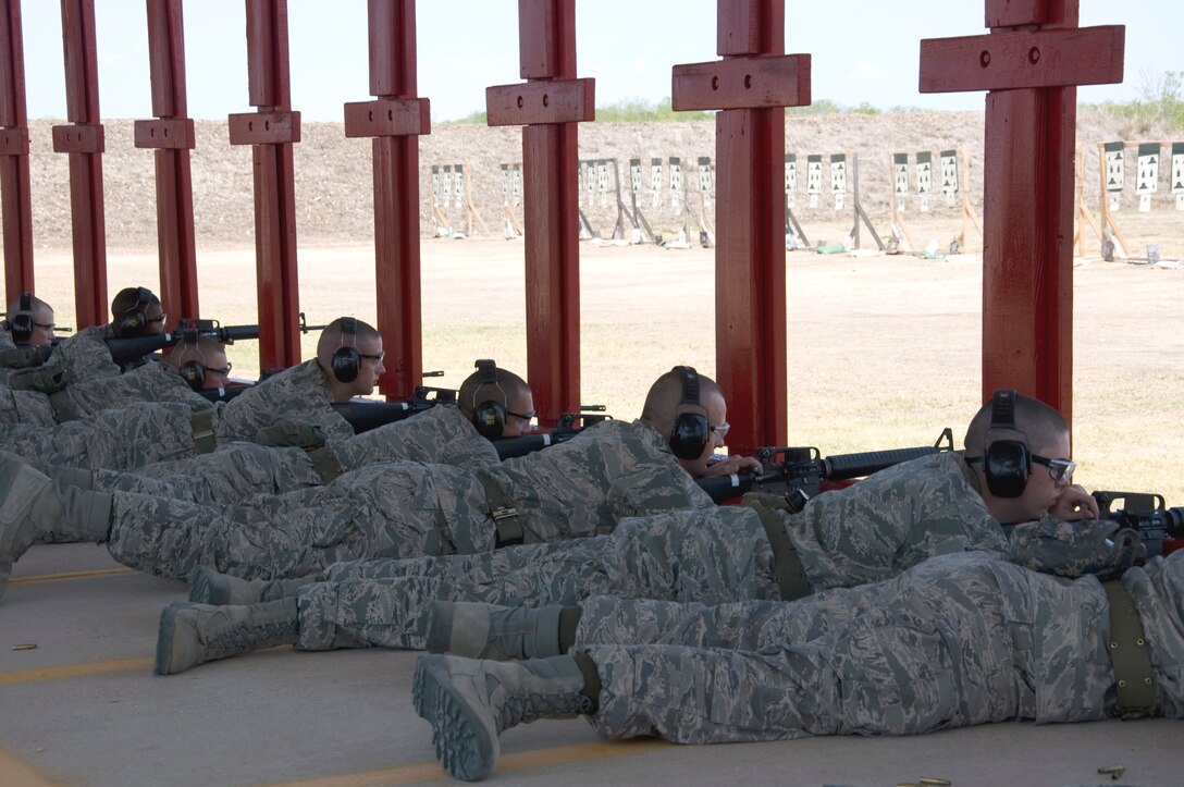 Trainees demonstrate the prone firing position at live fire course. (U.S. Air Force Photo/Melinda Mueller)
