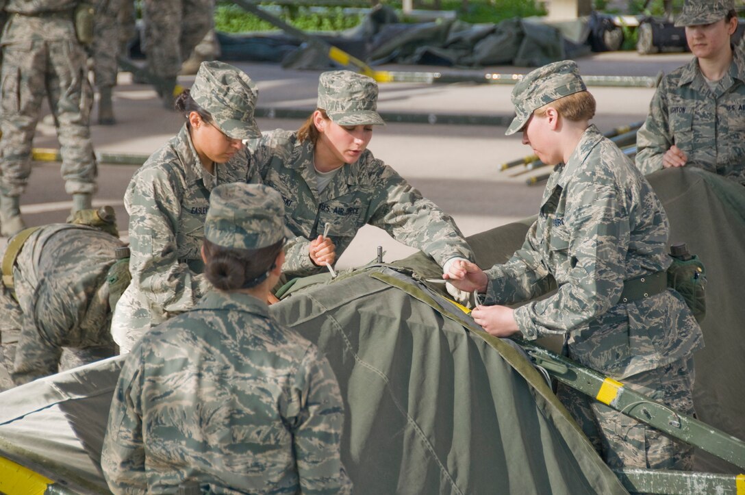 Trainees demonstrate teamwork skills while erecting a TEMPER Tent Shelter.  (U.S. Air Force Photo/Melinda Mueller)
