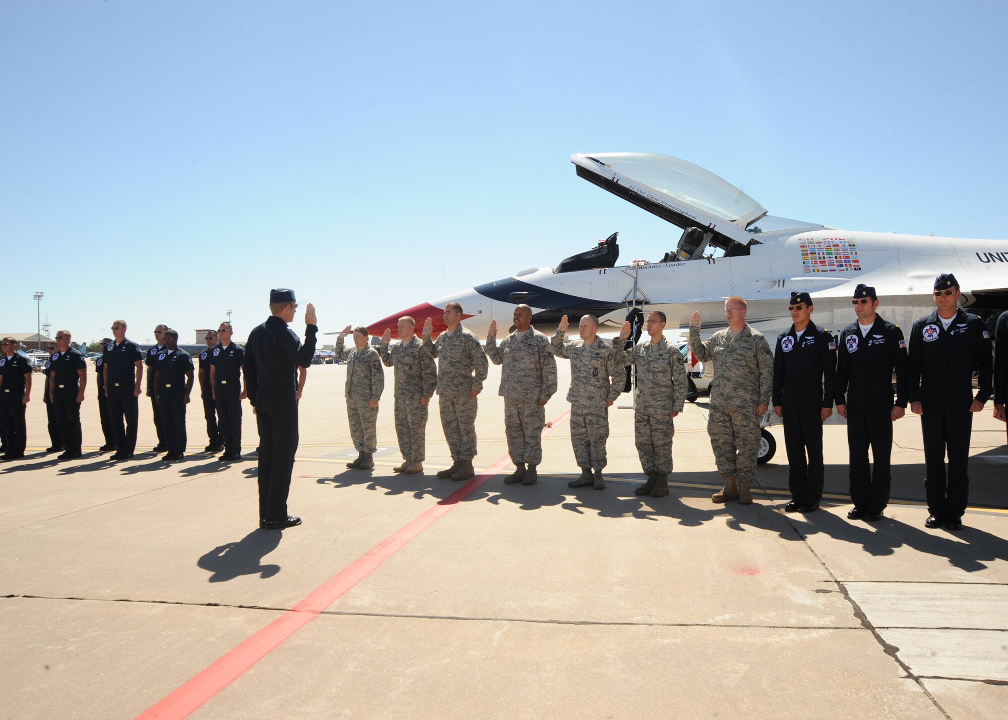 Lt. Col. Case Cunningham, U.S. Air Force Thunderbird Air Demonstration Squadron commander, reenlists McConnell Airmen prior to the Thunderbirds practice aerial demonstration Sept. 24, 2010, McConnell Air Force Base, Kan.  Master Sgt. Rebecca Smith, Tech. Sgt. Ryan Overcash, Staff Sgt. Jeremy Witmer, Staff Sgt. Christopher Kelley, Staff Sgt. Marques Myrick, Staff Sgt. Luis Hernandez and Senior Airman Walter Benson reenlisted.  (U.S. Air Force photo/Airman 1st Class Andrea Salazar)