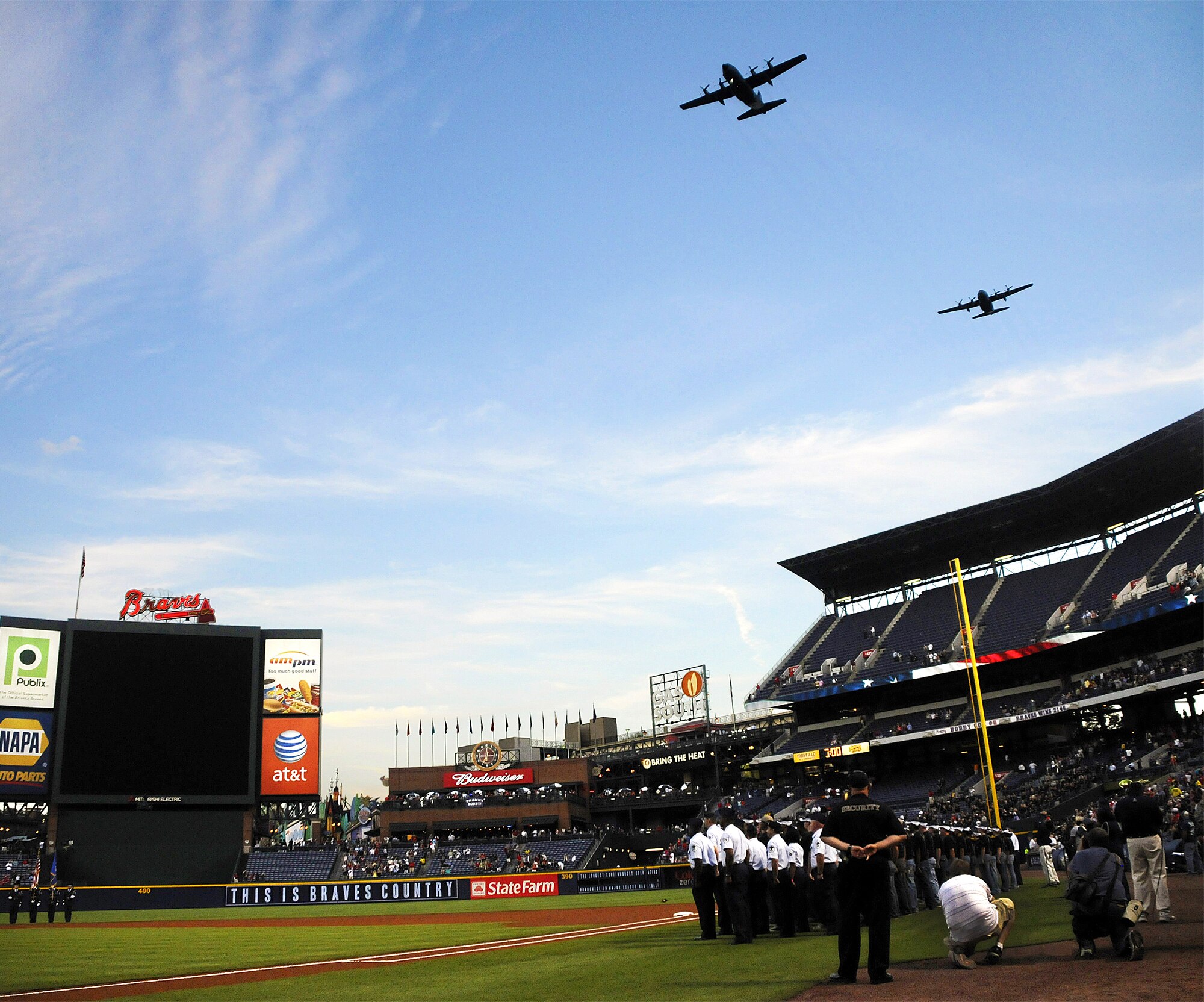 Two C-130 Hercules aircraft from Dobbins Air Reserve Base, Ga.,  punctuate a mass enlistment ceremony by flying over Turner Field prior to an Atlanta Braves' homegame Sept. 28, 2010. Seventy-nine new Air Force Reserve recruits took the oak of enlistment, which was administered by Lt. Gen.  Charles E. Stenner Jr., commander of Air Force Reserve Command.  The ceremony included presentation of colors by members of the Dobbins ARB Honor Guard. The Braves beat the Florida Marlins 3-2. (U.S. Air Force photo/Tech. Sgt. Paul Flipse)