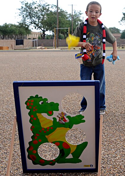 Victor Gonzalez Jr. hits the target with his bean bag toss Sept. 25 at the Cannon Air Force Base Youth Center. Children spent an afternoon running, jumping and tossing during the annual "Worldwide Day of Play." (U.S. Air Force photo by Greg Allen)