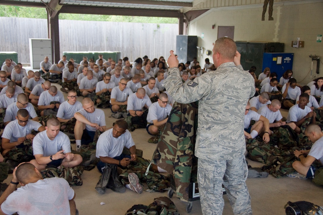 Instructor demonstrating how to wear the Joint Service Lightweight Integrated 
Suit Technology during Chemical, Biological, Radiological, Nuclear and High-Yield Explosive class. (U.S. Air Force Photo/Melinda Mueller)
